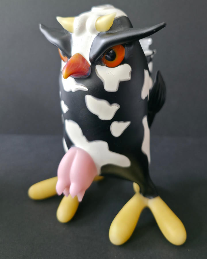 Cow-shaped glass rig with a black and white pattern on a dark background