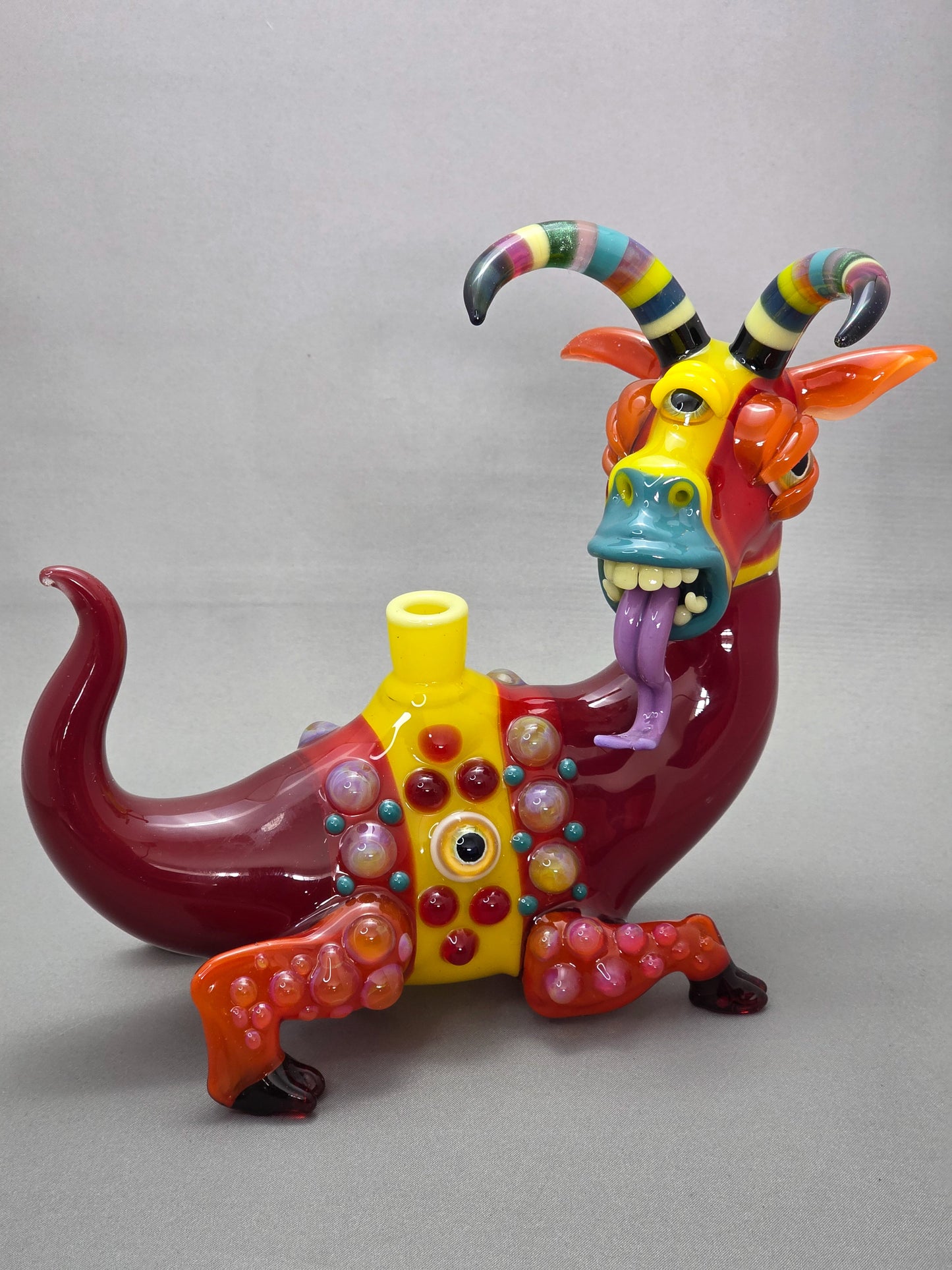 Robertson Glass Colourful glass Goat sculpture on a grey background