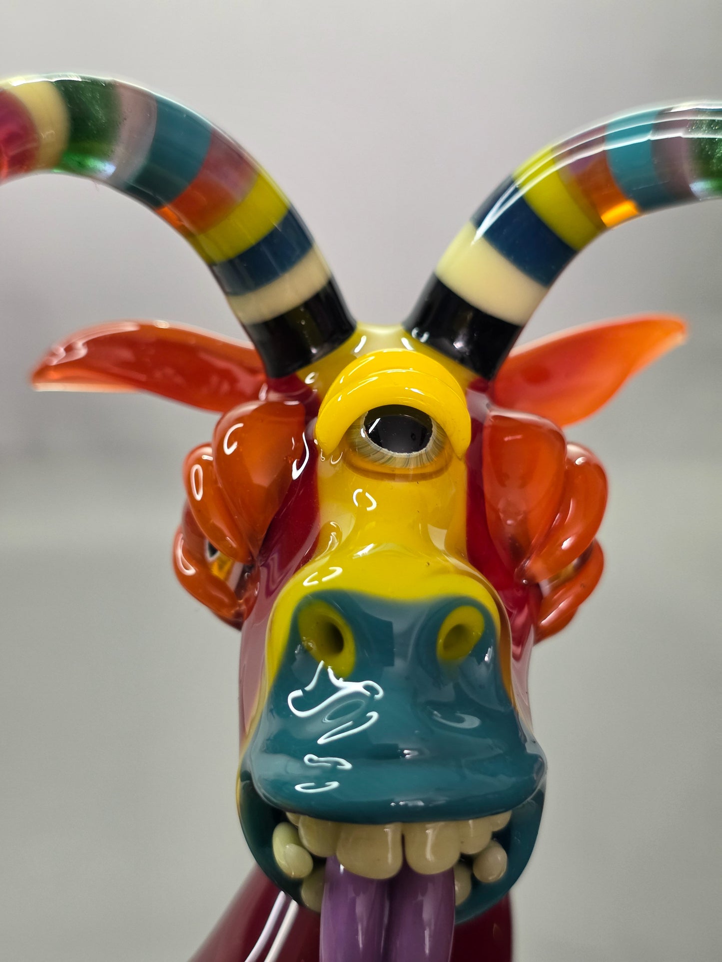 Robertson Glass Colourful glass Goat sculpture on a grey background