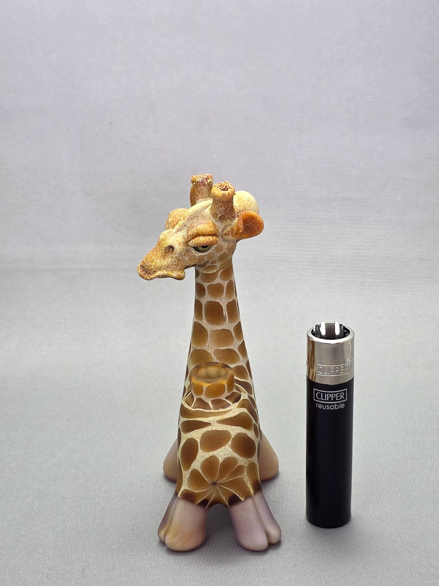Robertson Glass Giraffe-shaped glass pipe on a light grey background