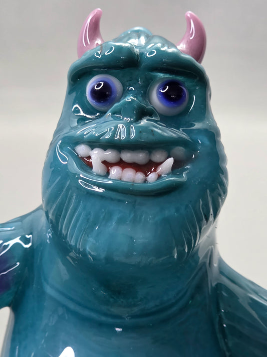 Robertson Glass Rig Blue monster figurine with purple spots on a white background