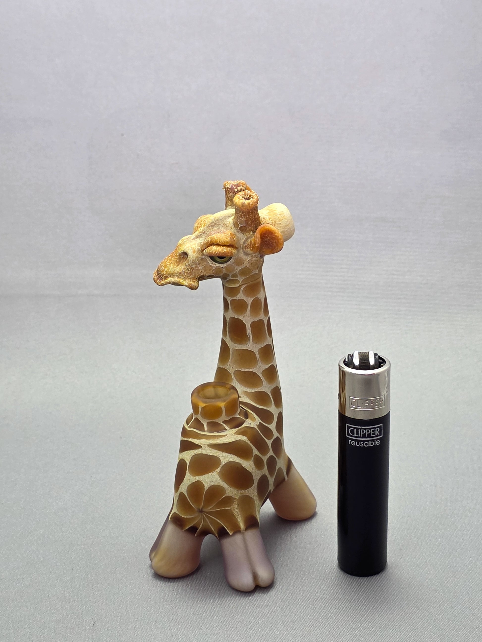 Robertson Glass Giraffe-shaped glass pipe on a light grey background