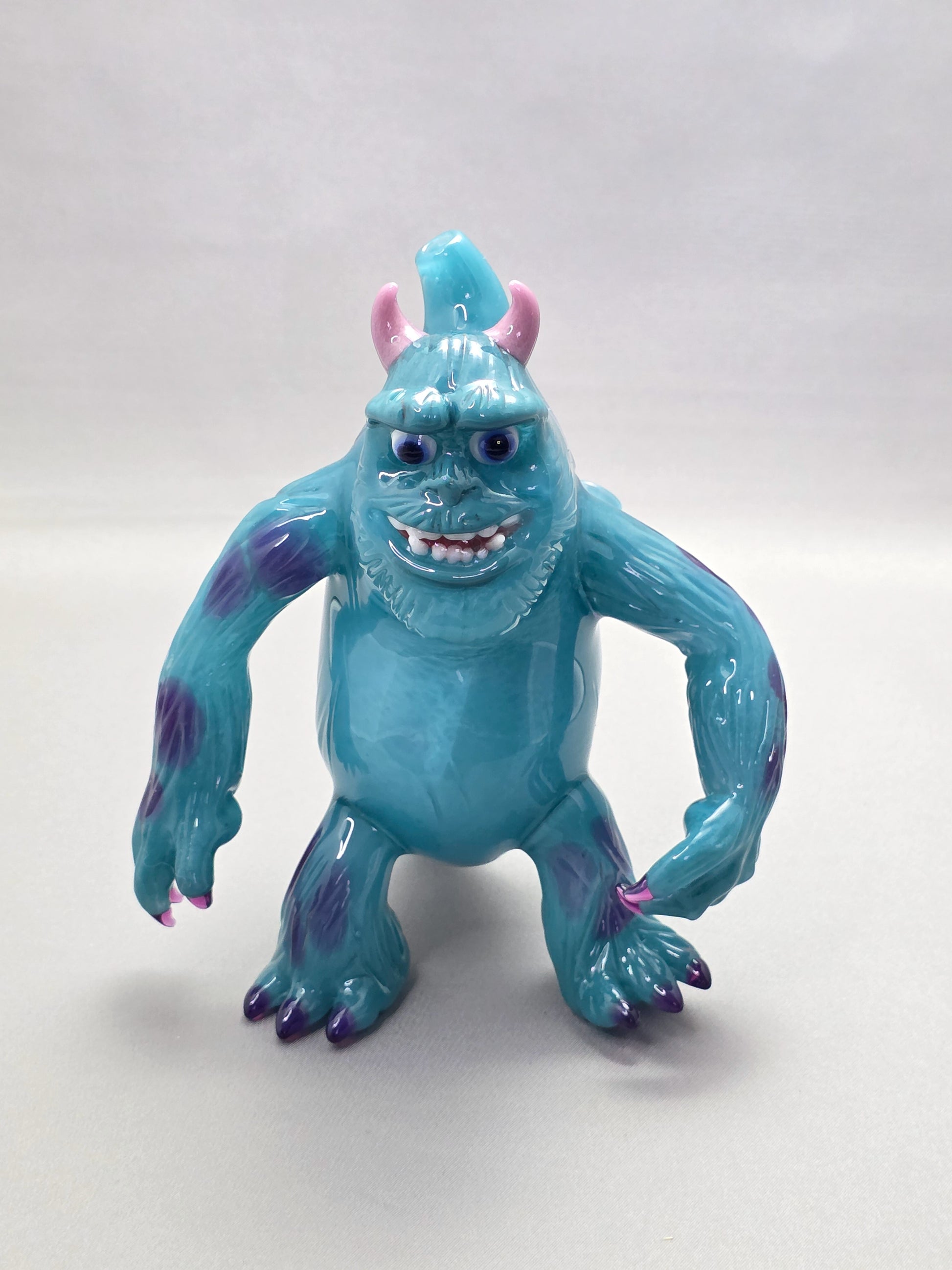 Robertson Glass Rig Blue monster figurine with purple spots on a white background
