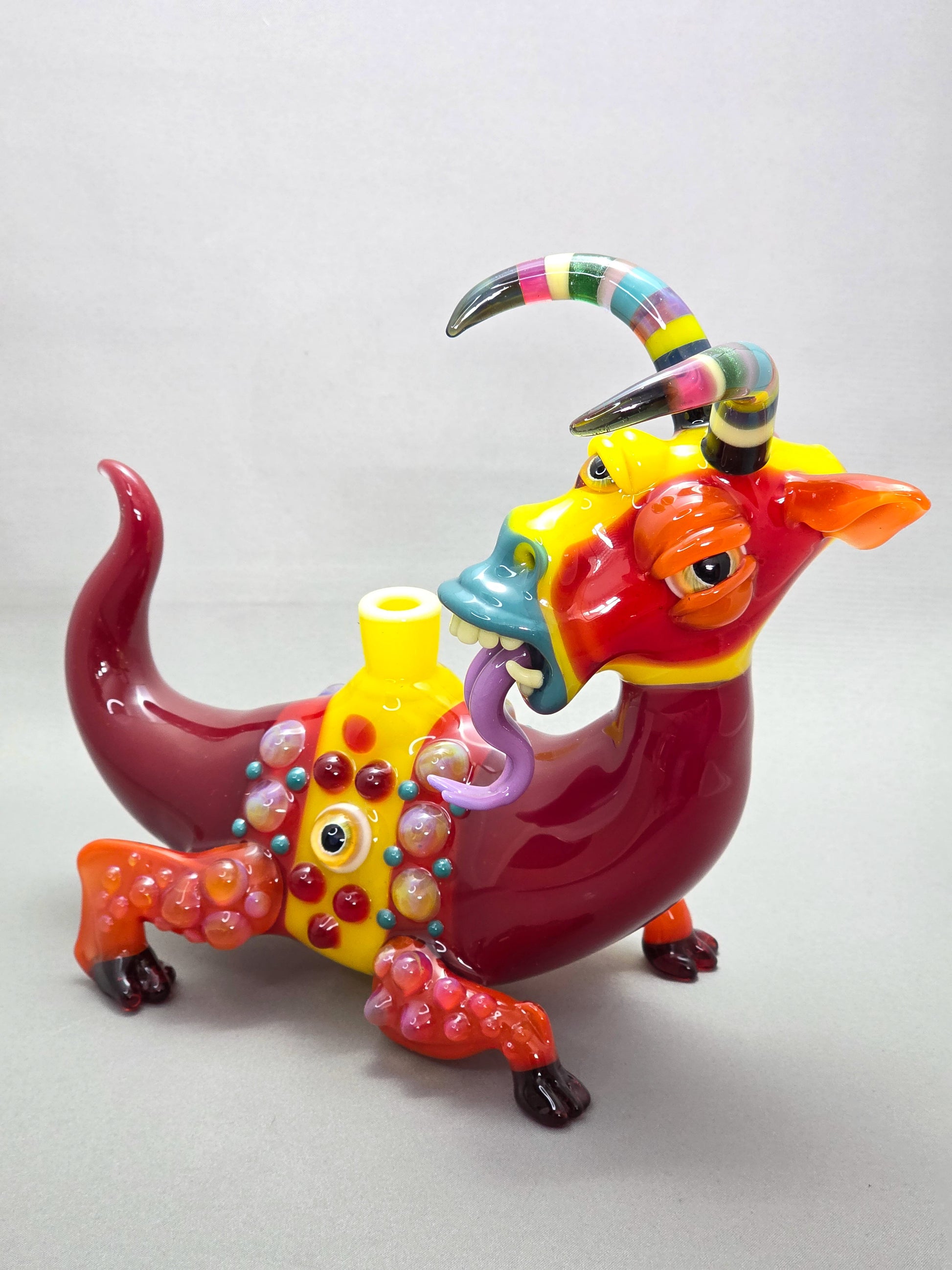 Robertson Glass Colourful glass Goat sculpture on a grey background