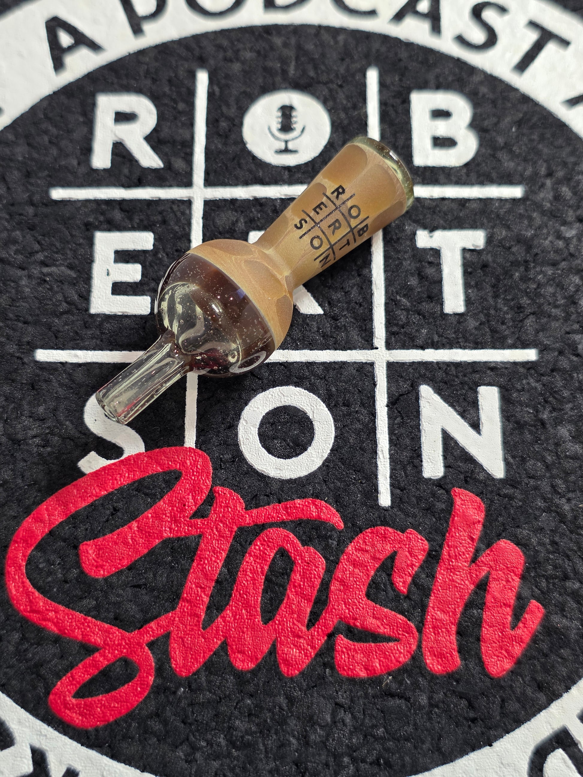 Amber-colored quartz top cap on a black and white target with ' Robertson and Stash' branding.