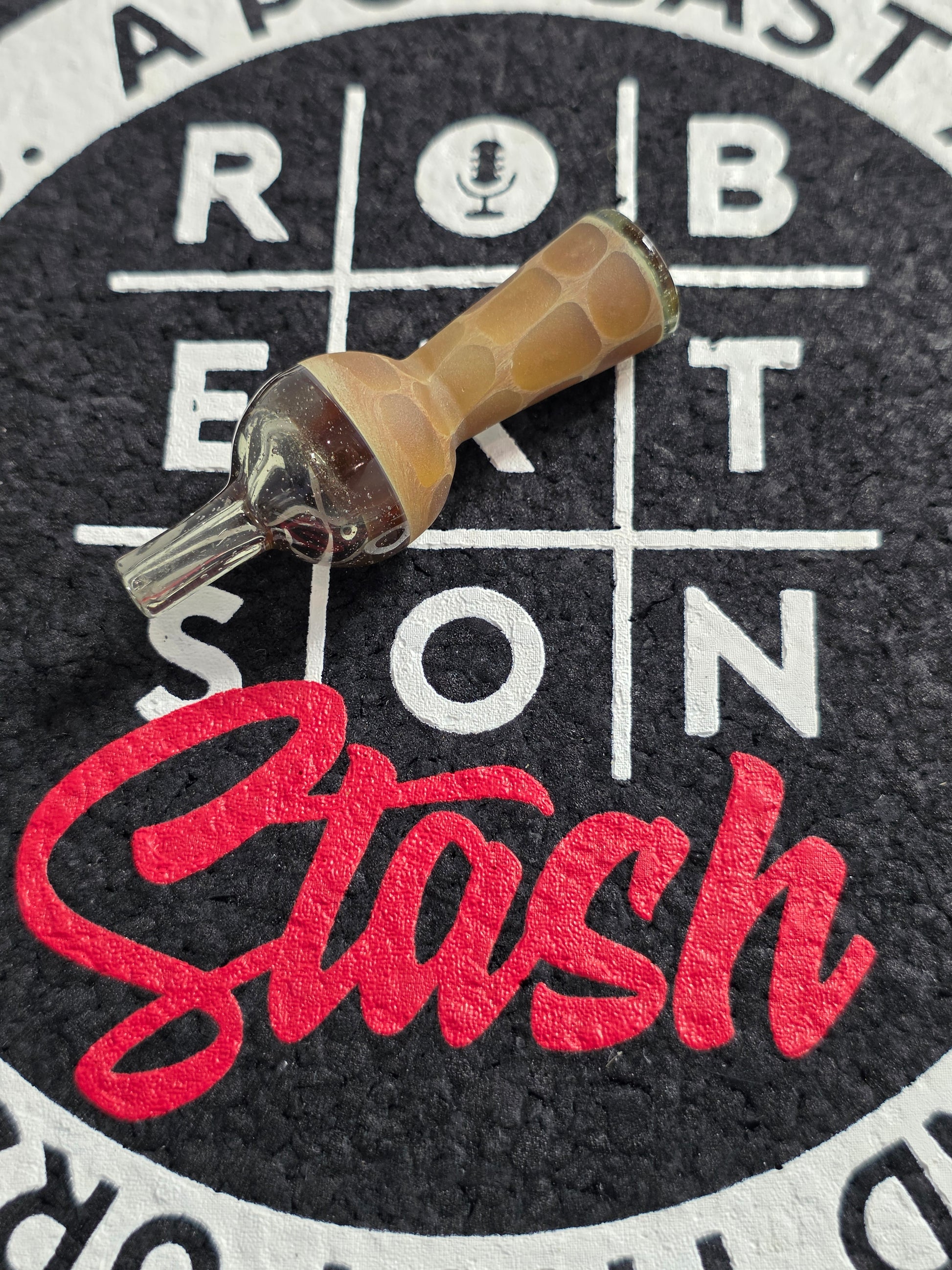 Amber-colored quartz top cap on a black and white target with ' Robertson and Stash' branding.