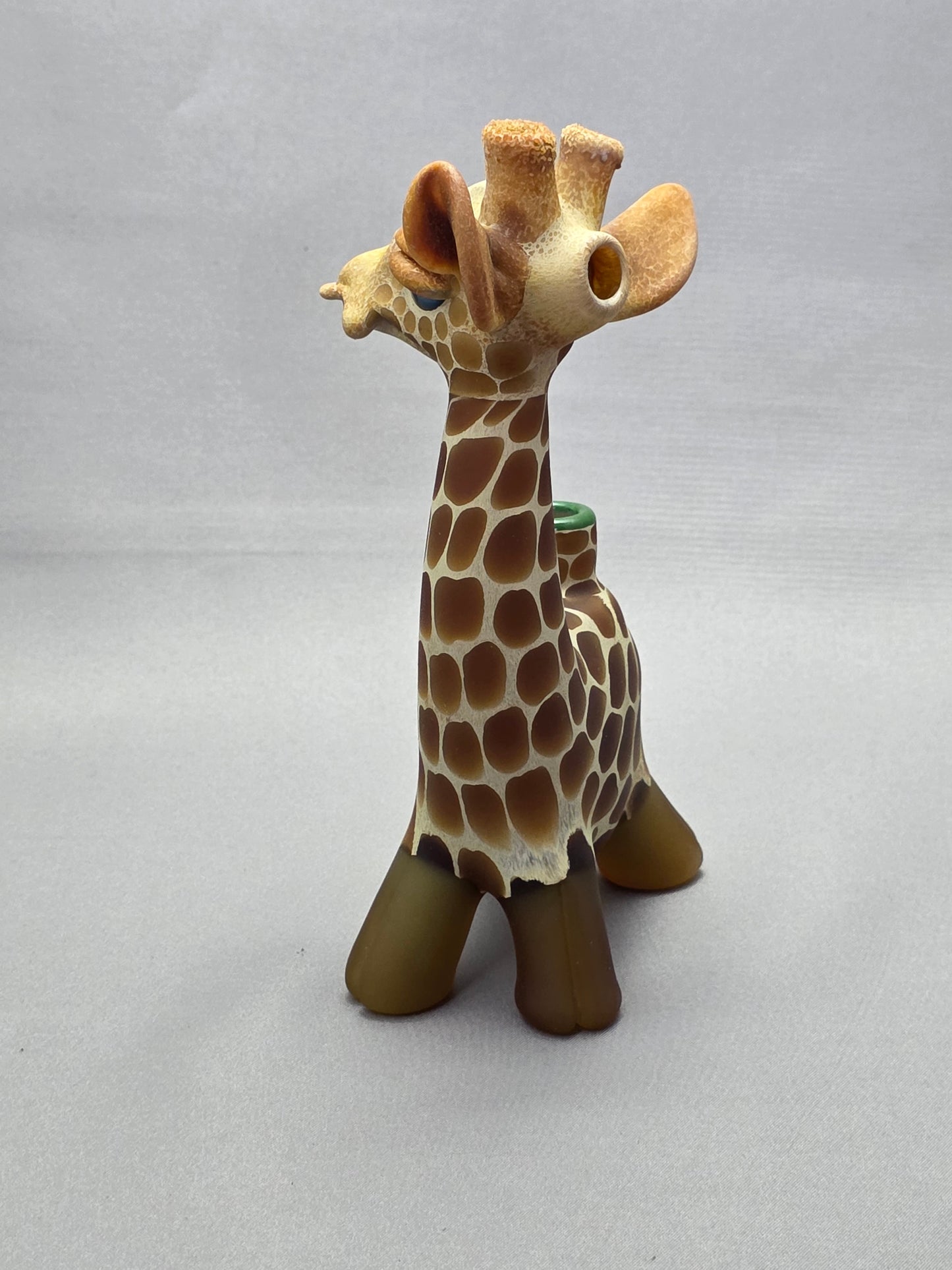 Robertson Glass Giraffe-shaped glass pipe on a light grey background