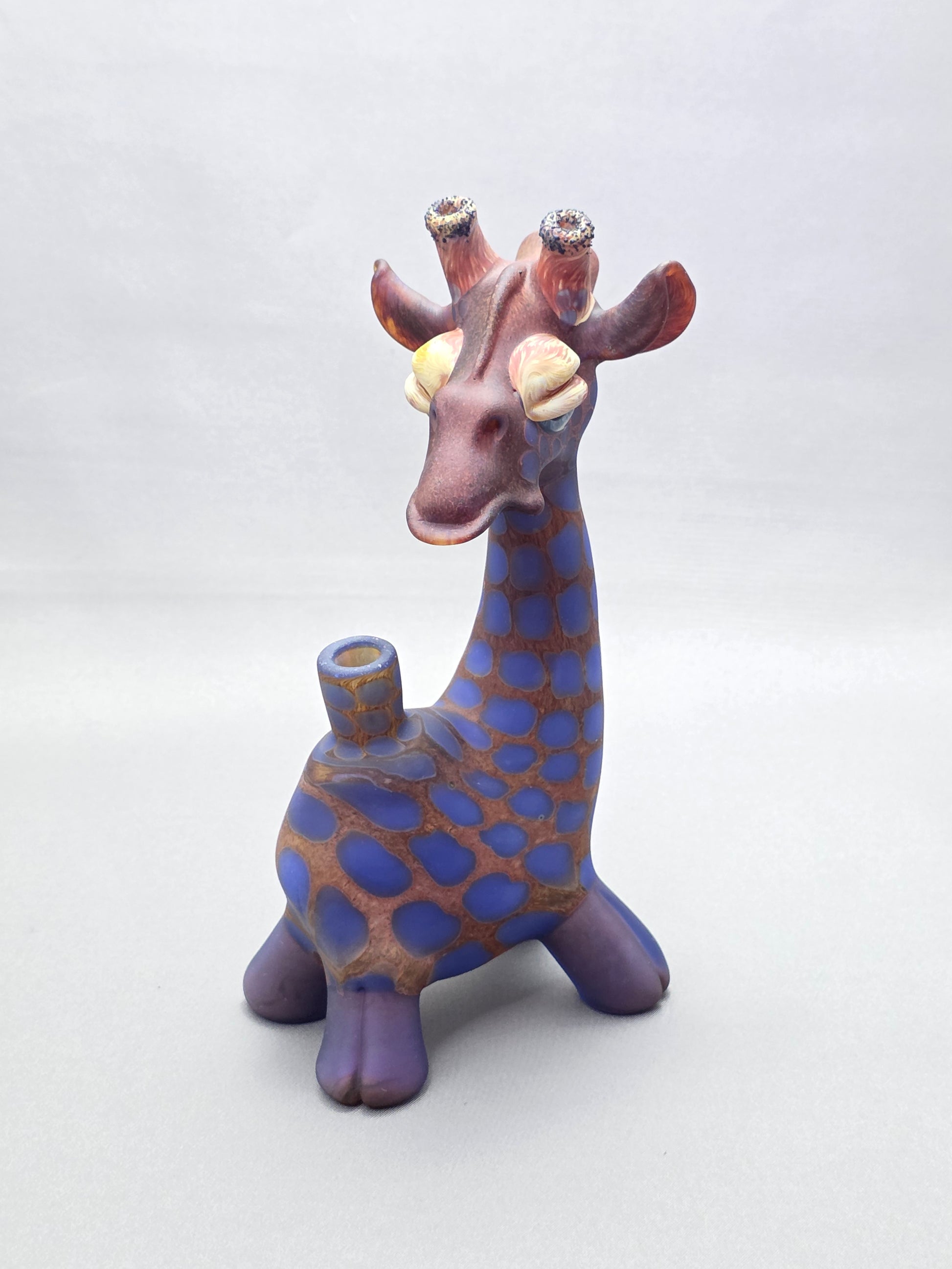 Robertson Glass Giraffe-shaped glass pipe on a light grey background