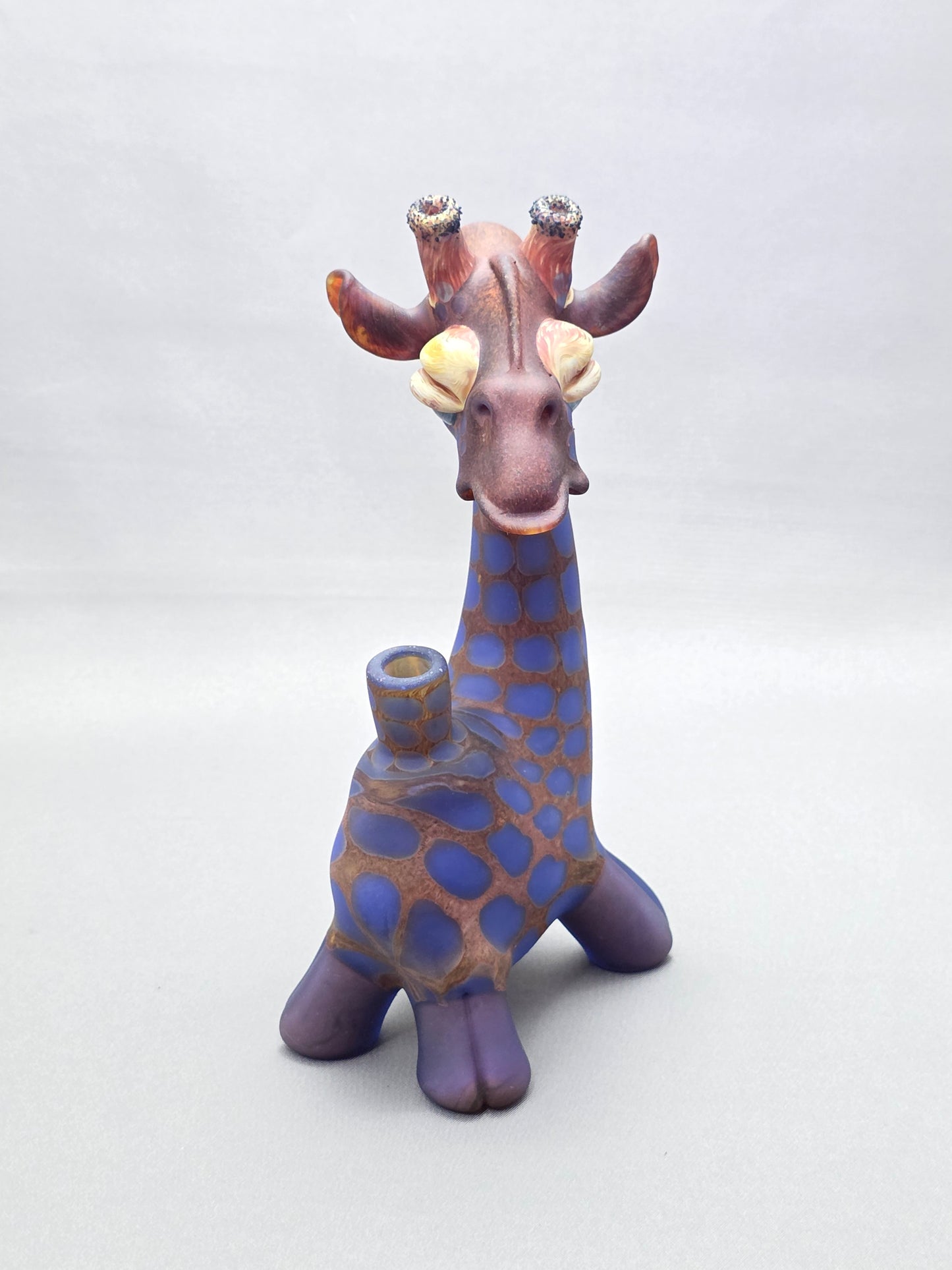 Robertson Glass Giraffe-shaped glass pipe on a light grey background