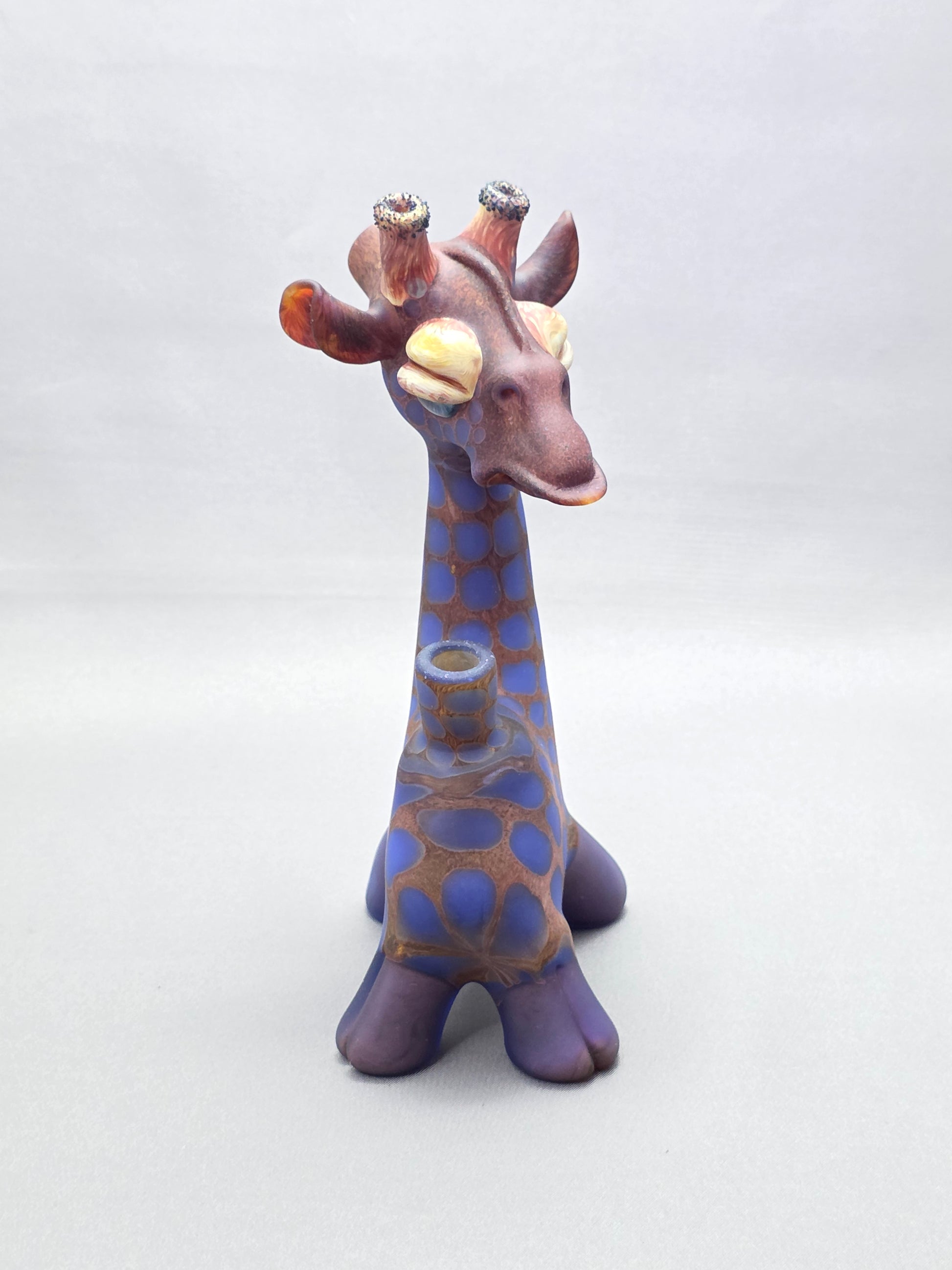 Robertson Glass Giraffe-shaped glass pipe on a light grey background