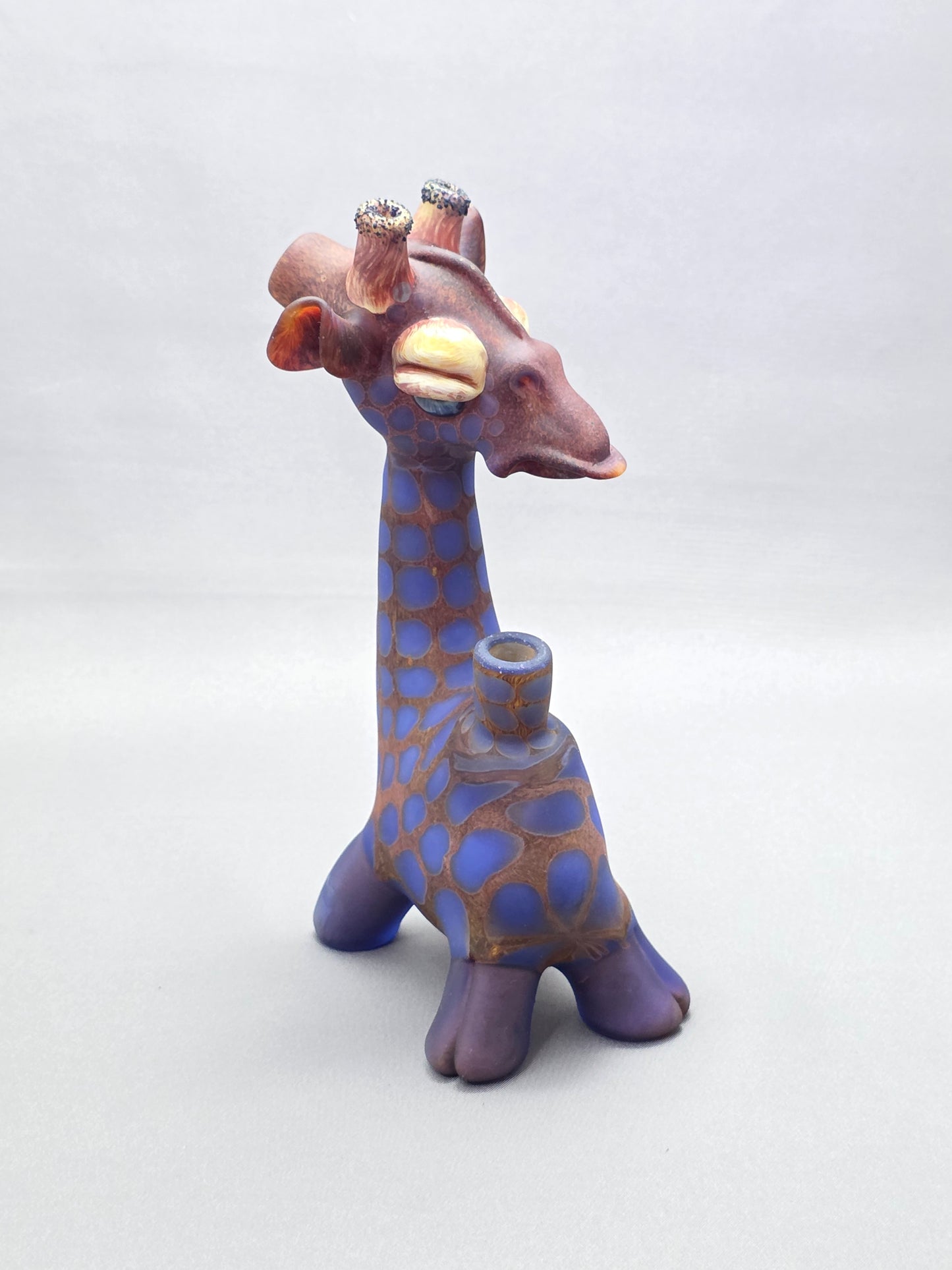 Robertson Glass Giraffe-shaped glass pipe on a light grey background