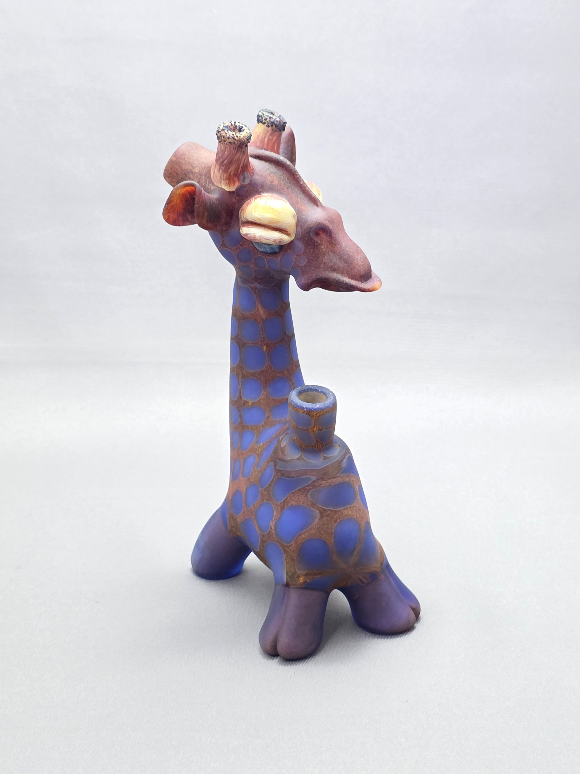 Robertson Glass Giraffe-shaped glass pipe on a light grey background