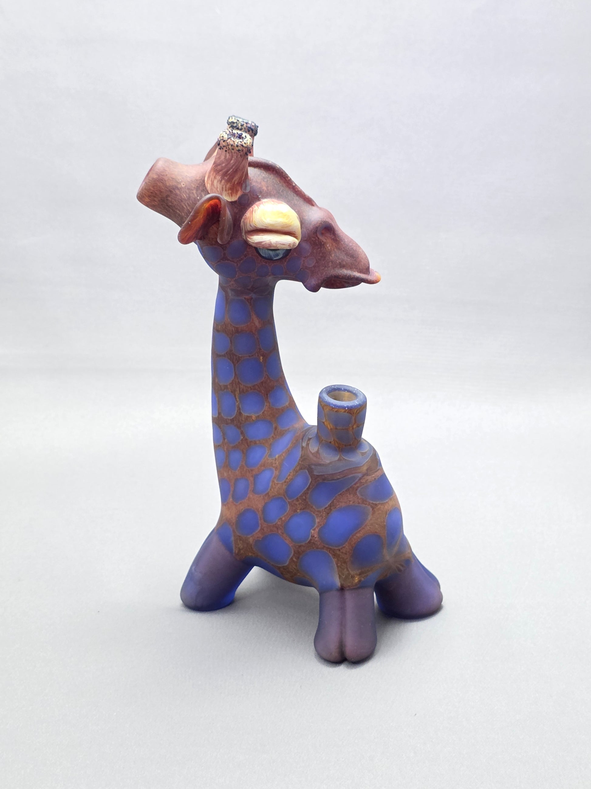 Robertson Glass Giraffe-shaped glass pipe on a light grey background