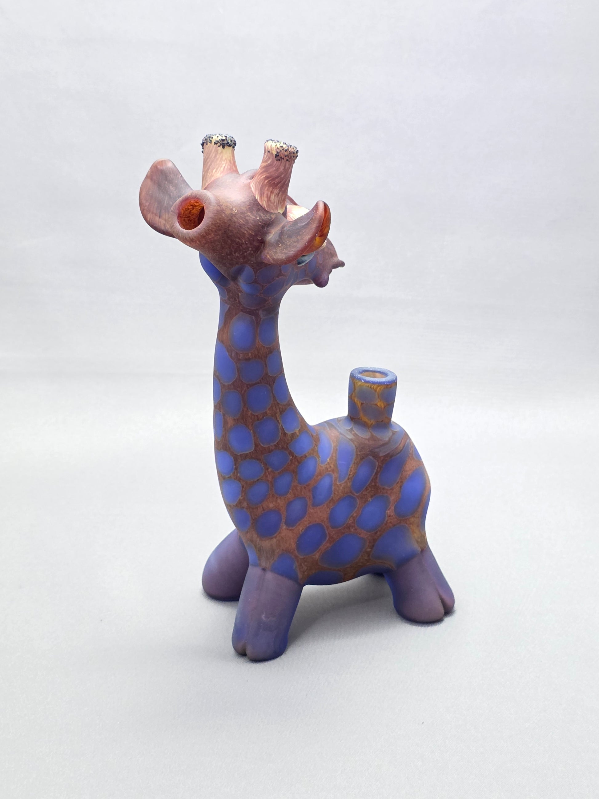 Robertson Glass Giraffe-shaped glass pipe on a light grey background