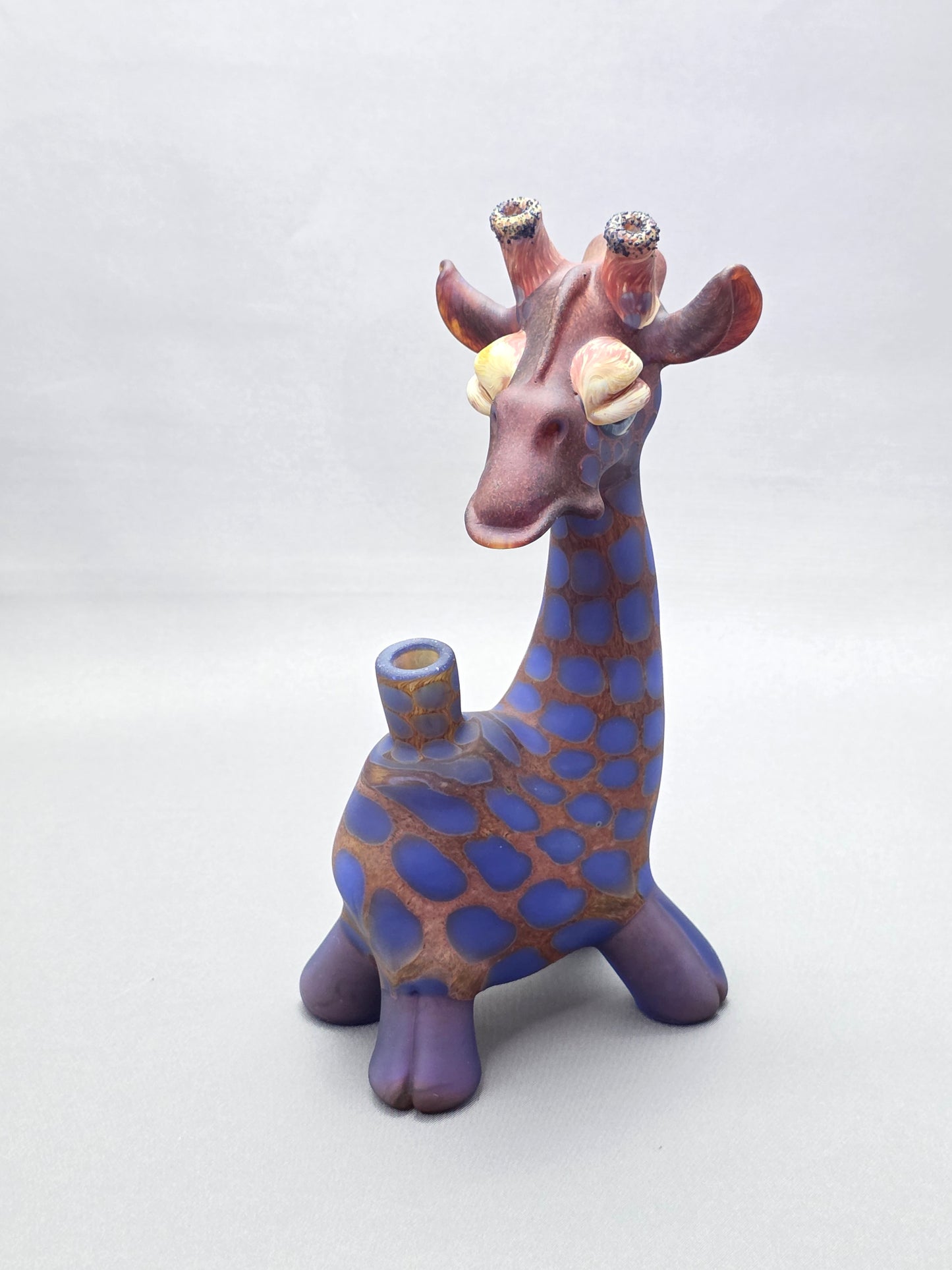 Robertson Glass Giraffe-shaped glass pipe on a light grey background