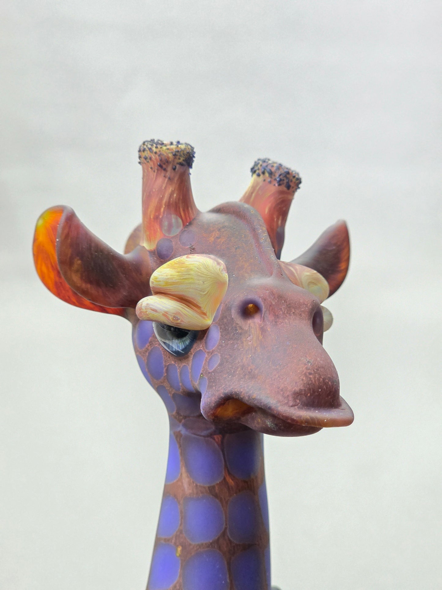 Robertson Glass Giraffe-shaped glass pipe on a light grey background