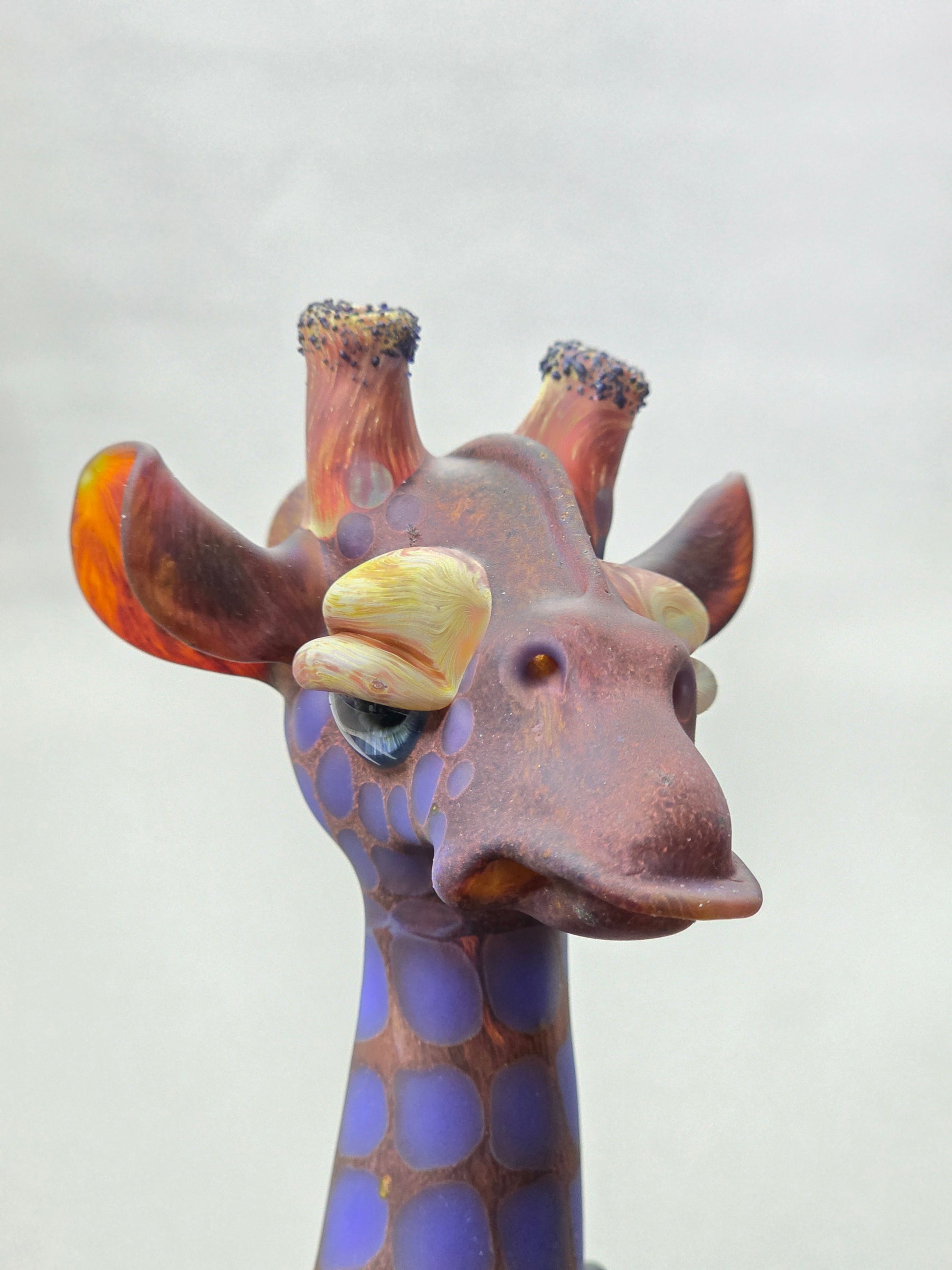 Robertson Glass Giraffe-shaped glass pipe on a light grey background