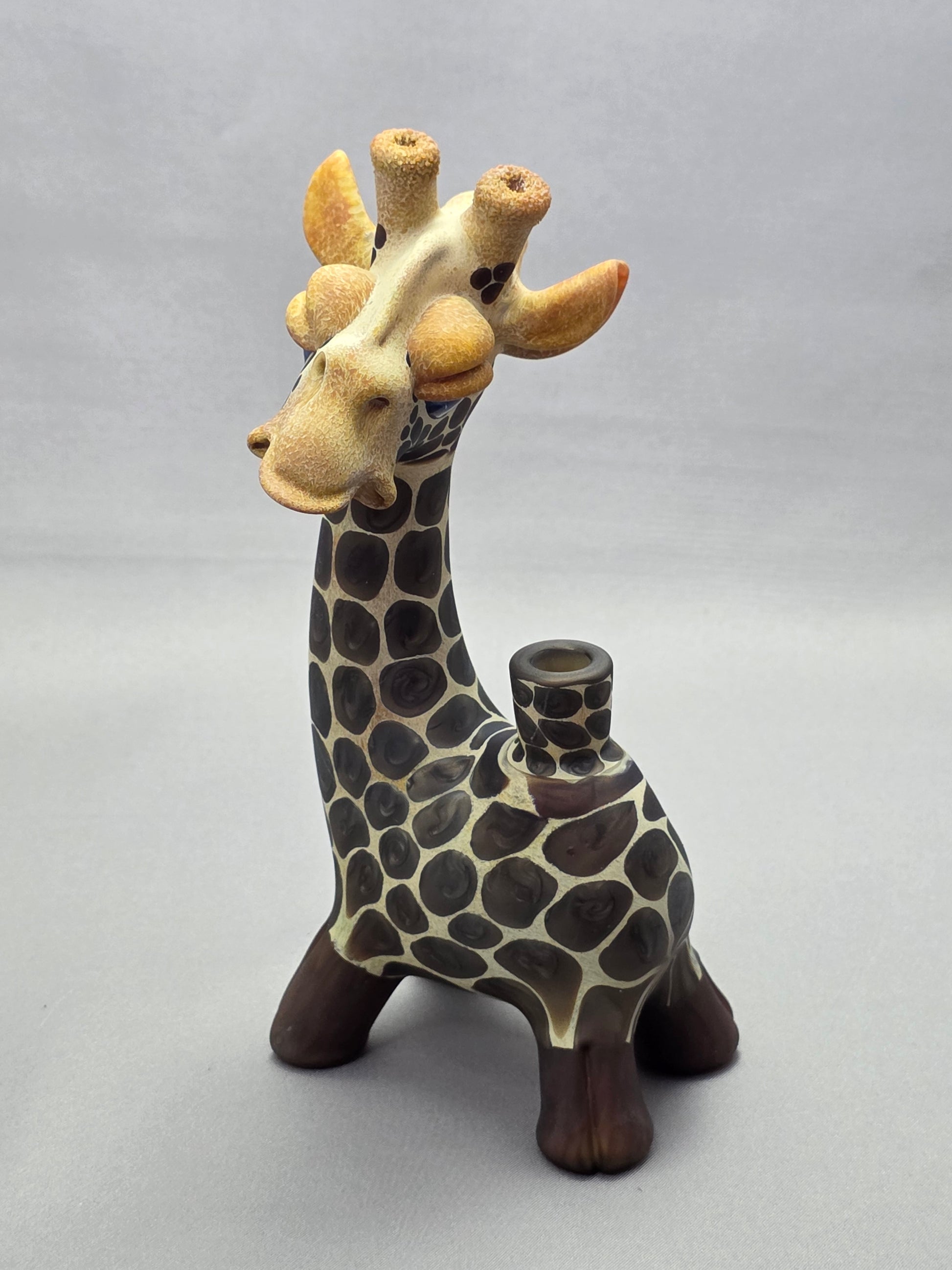 Robertson Glass Giraffe-shaped glass pipe on a light grey background