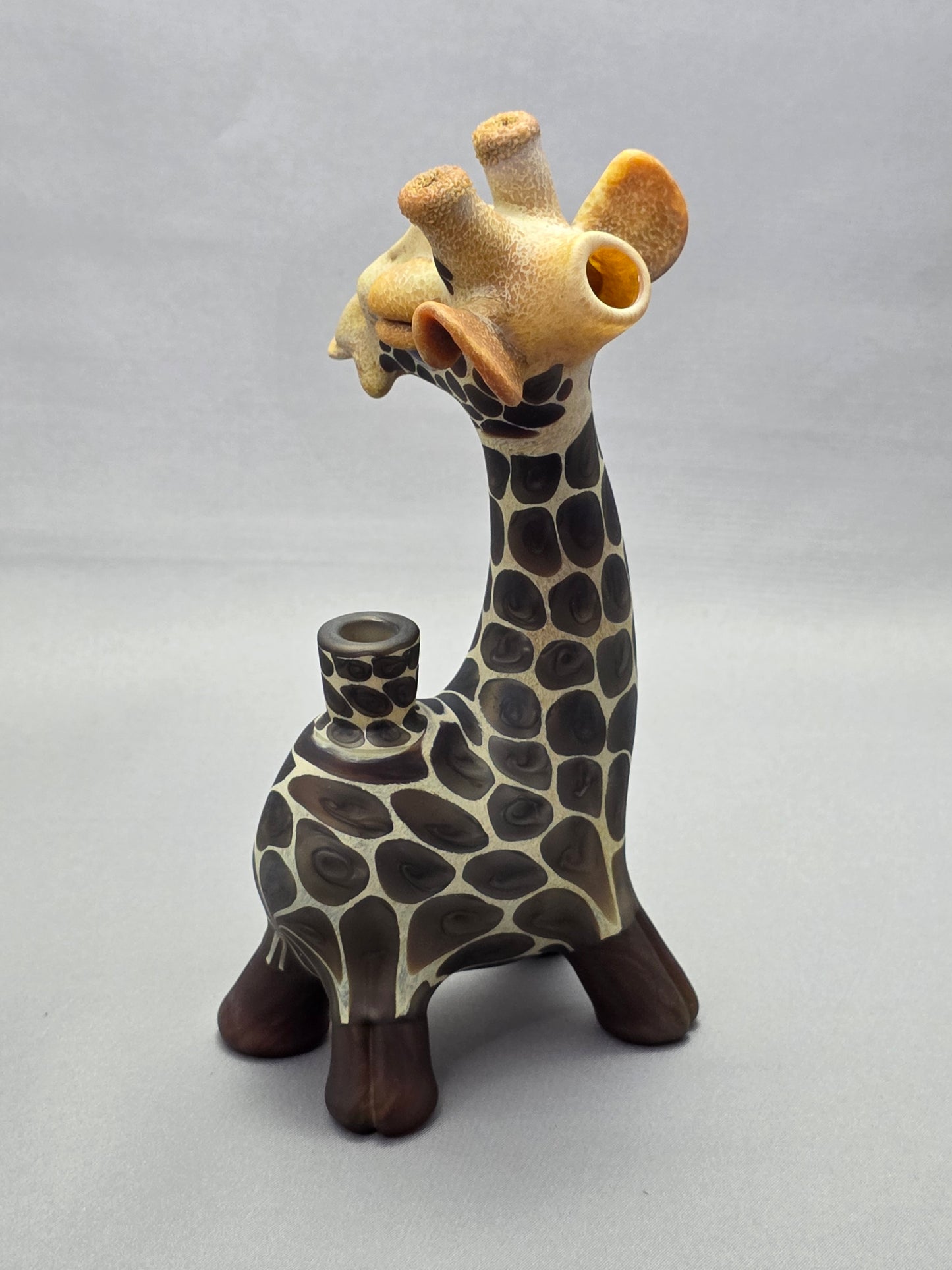 Robertson Glass Giraffe-shaped glass pipe on a light grey background
