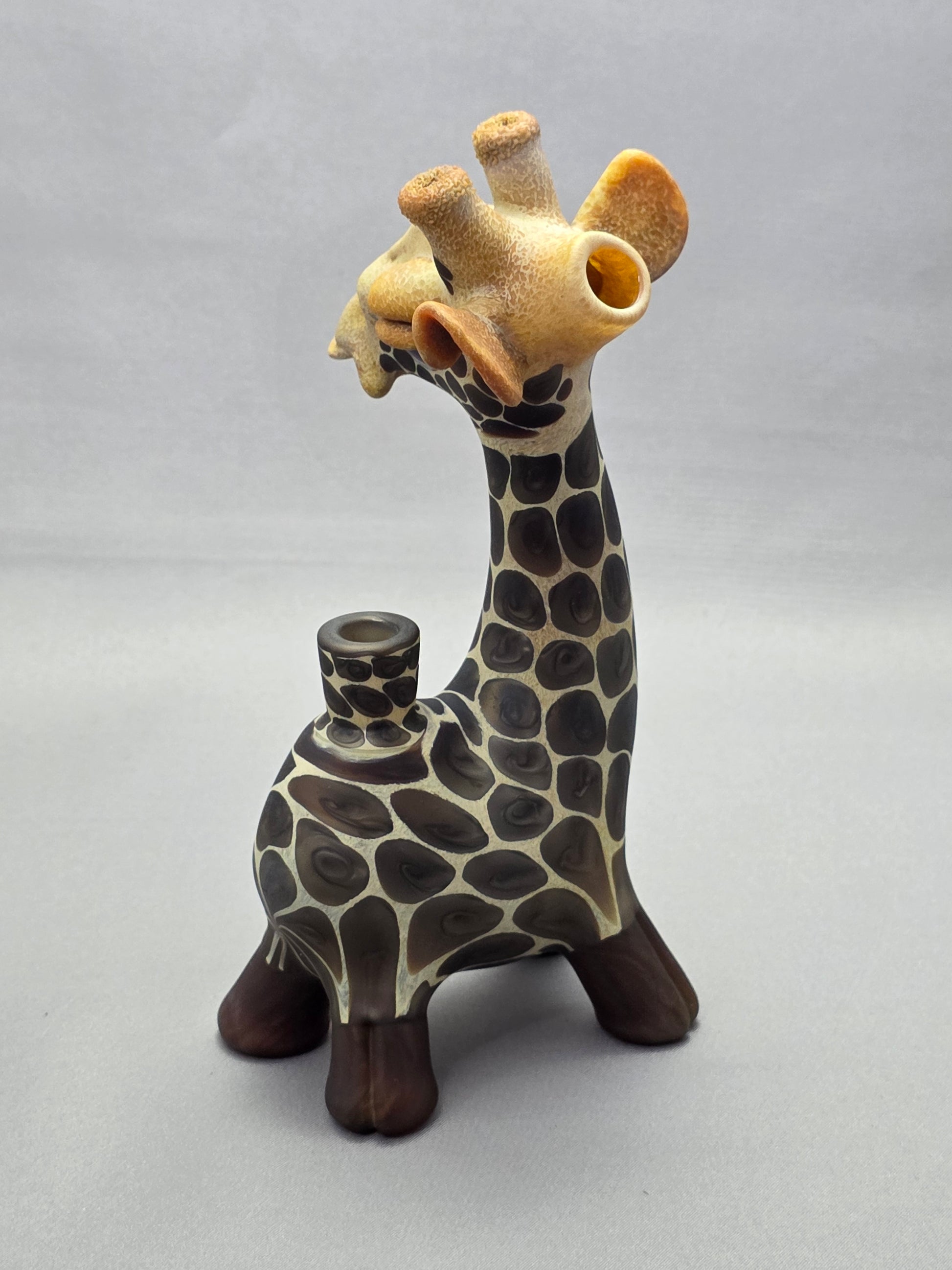 Robertson Glass Giraffe-shaped glass pipe on a light grey background