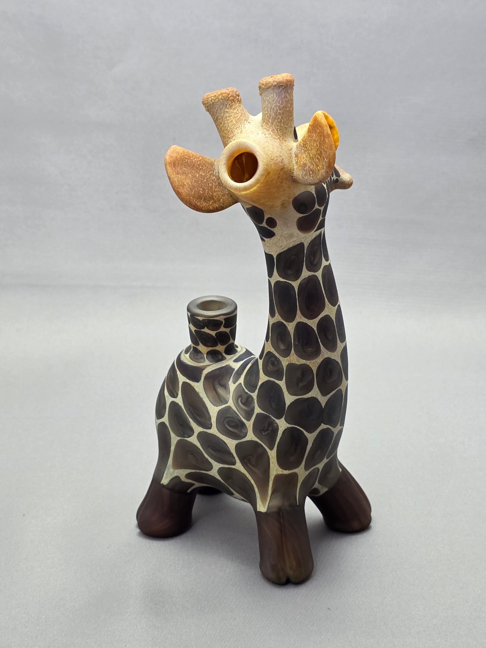 Robertson Glass Giraffe-shaped glass pipe on a light grey background
