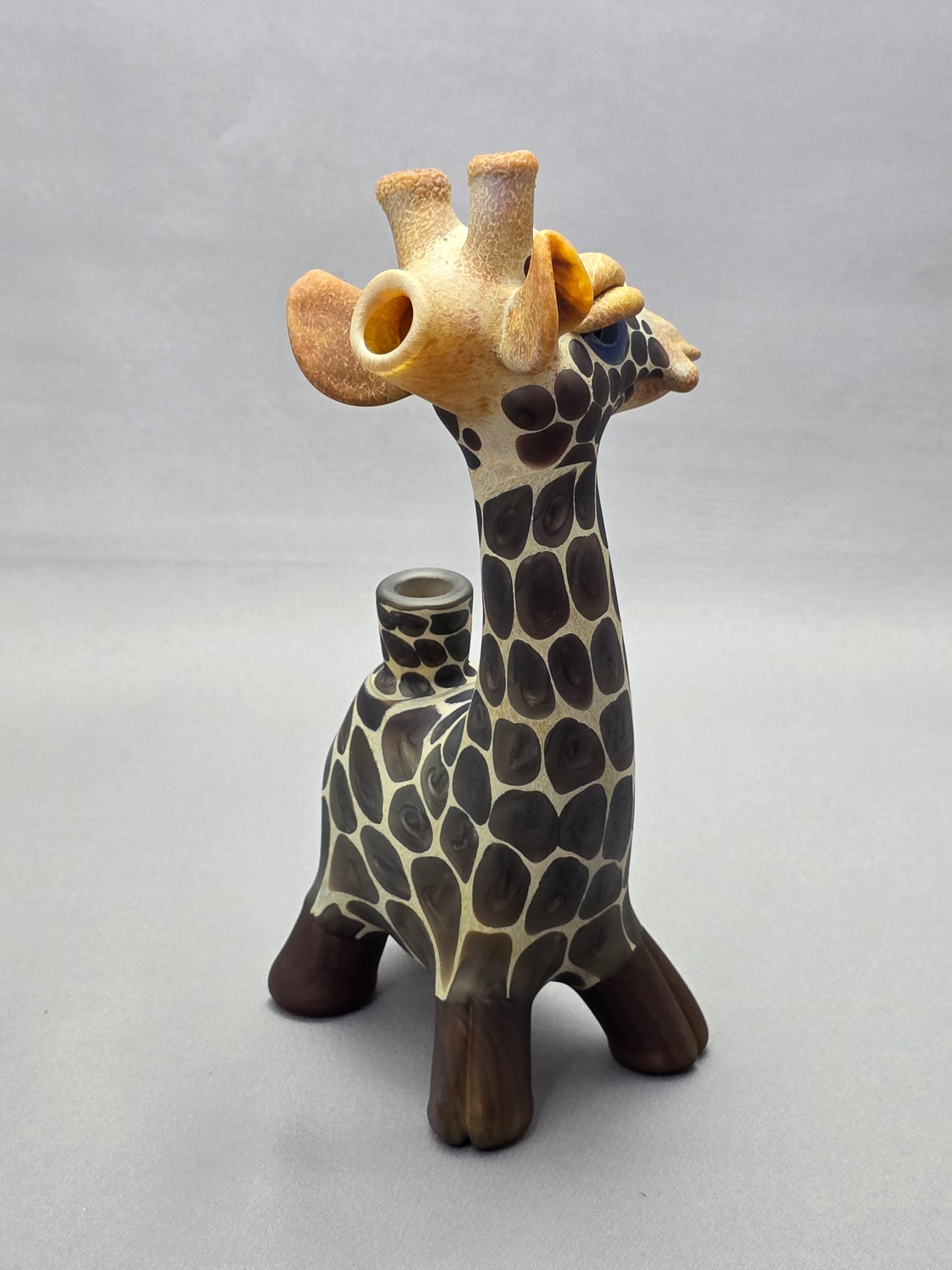 Robertson Glass Giraffe-shaped glass pipe on a light grey background