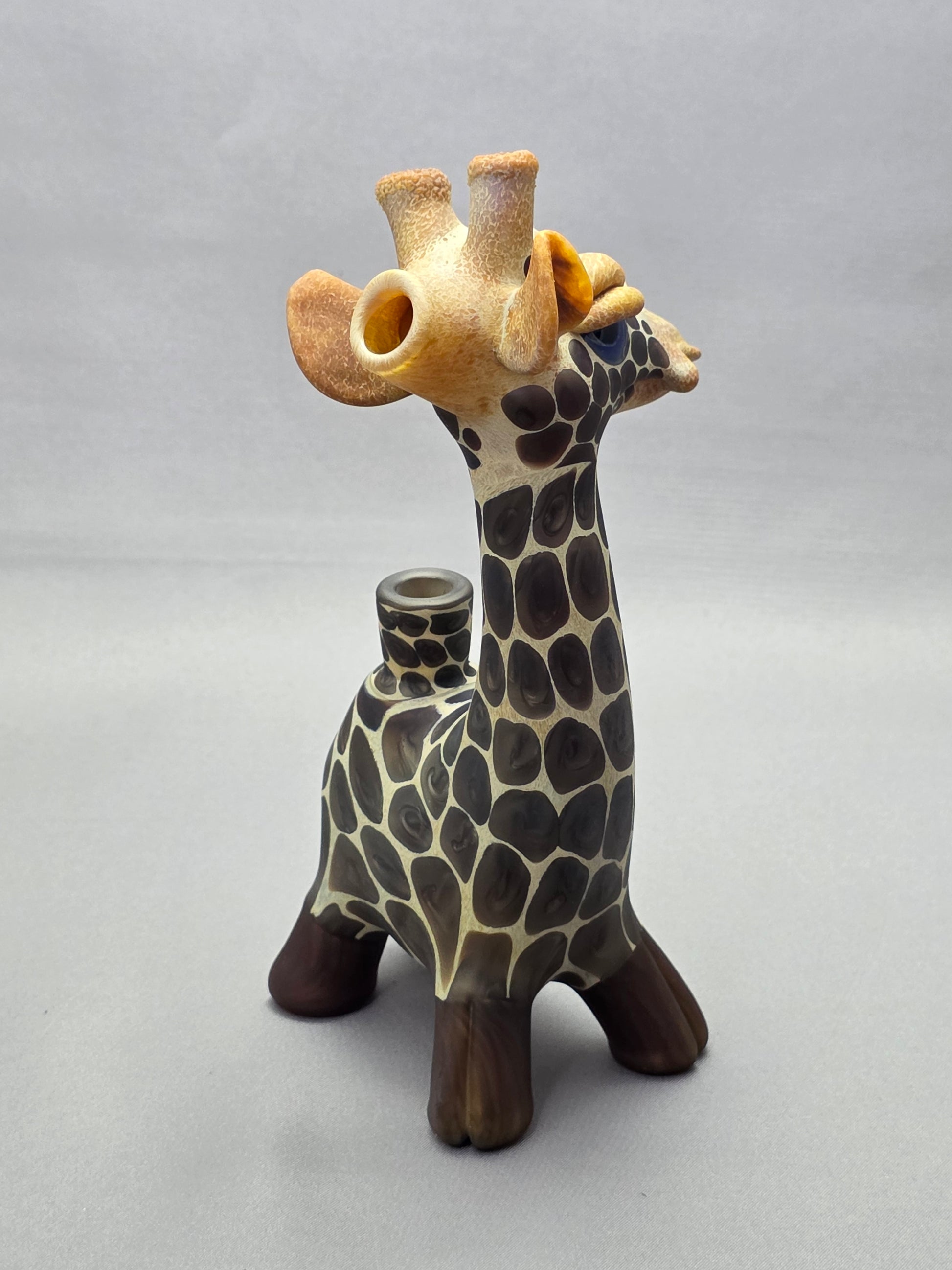 Robertson Glass Giraffe-shaped glass pipe on a light grey background