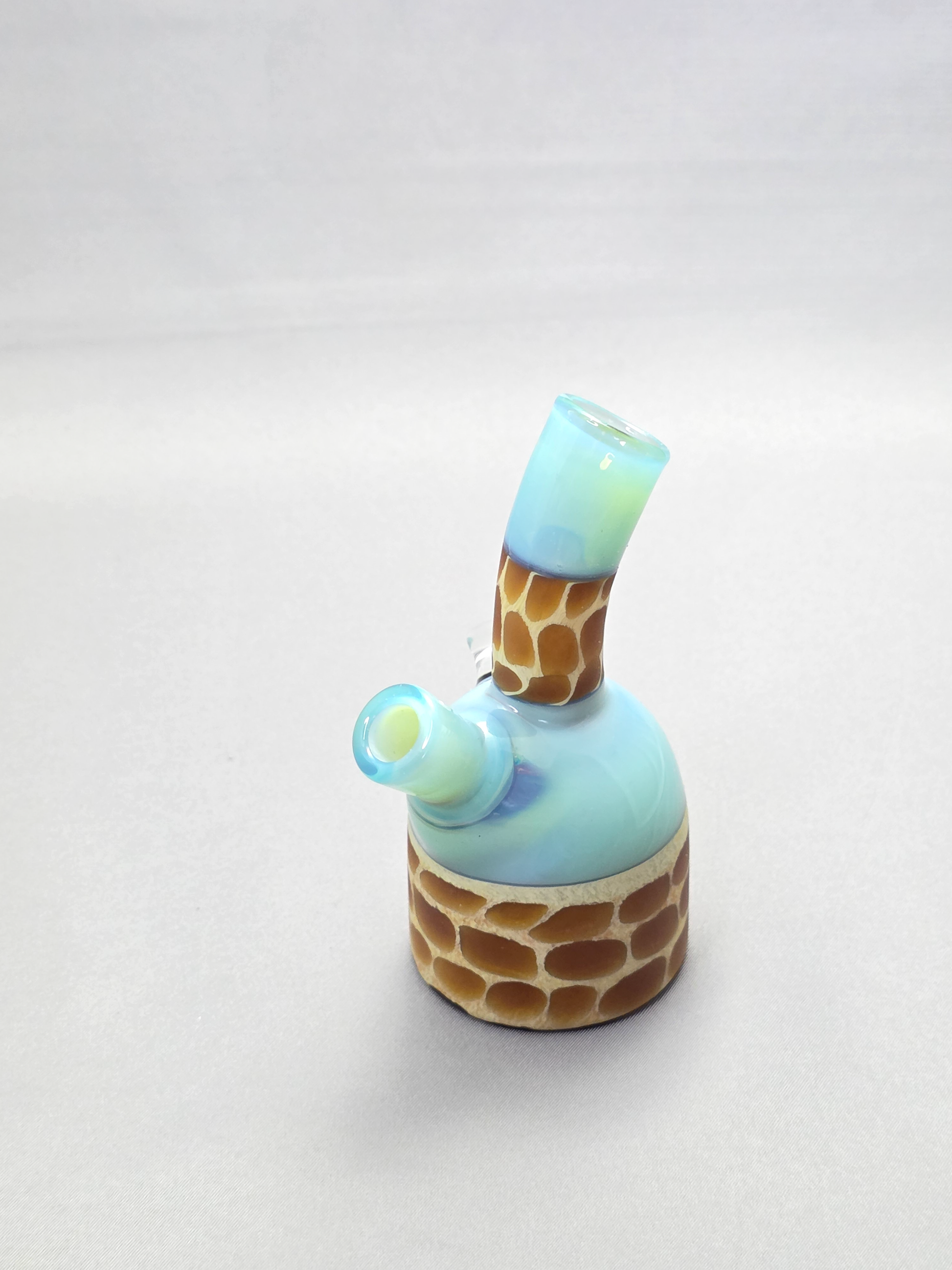 Robertson Glass blue giraffe pattern glass rig on a light grey background
