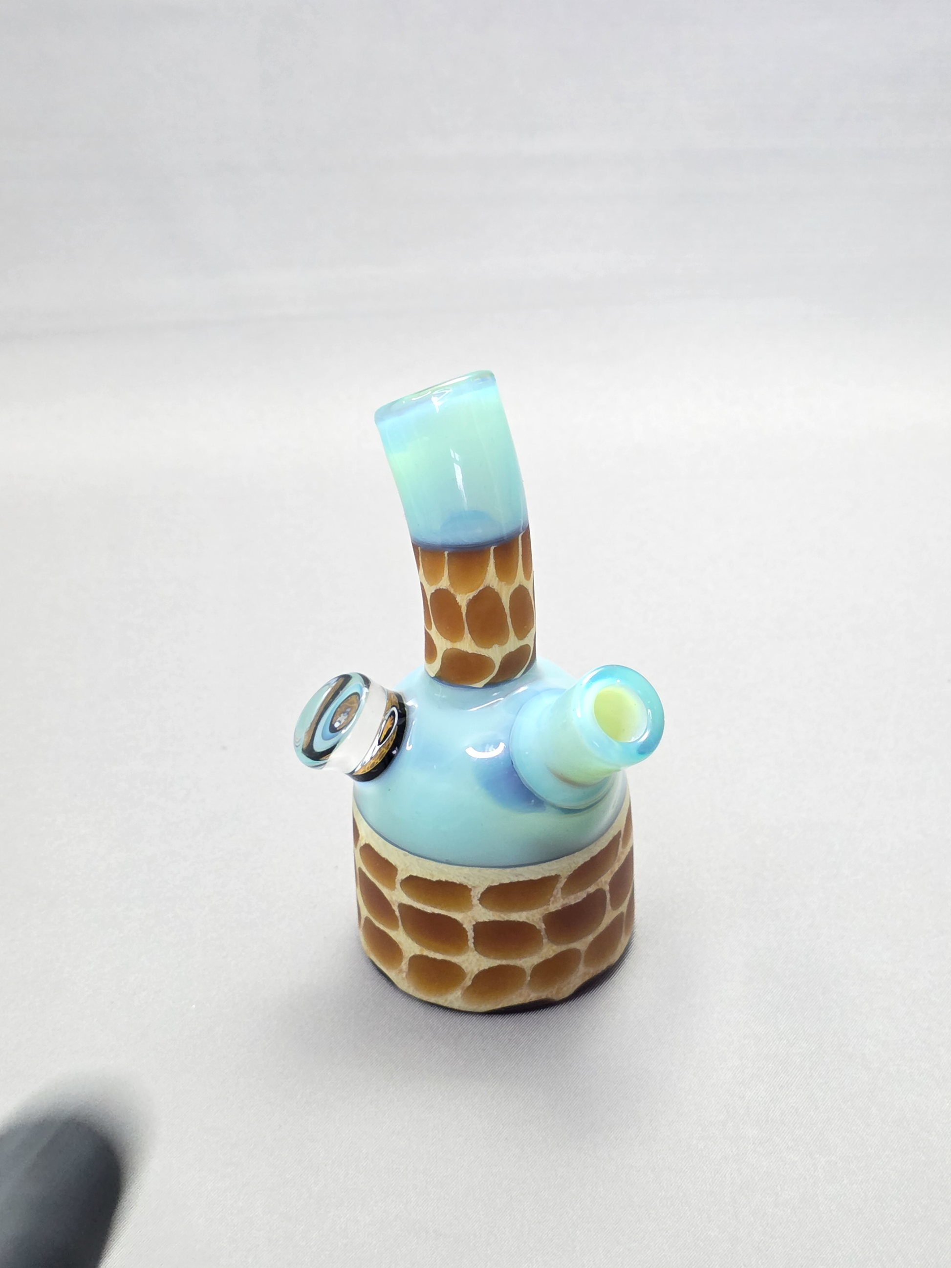 Robertson Glass blue giraffe pattern glass rig on a light grey background