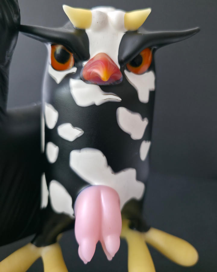 Cow-shaped Robertson glass rig with a black and white pattern on a dark background