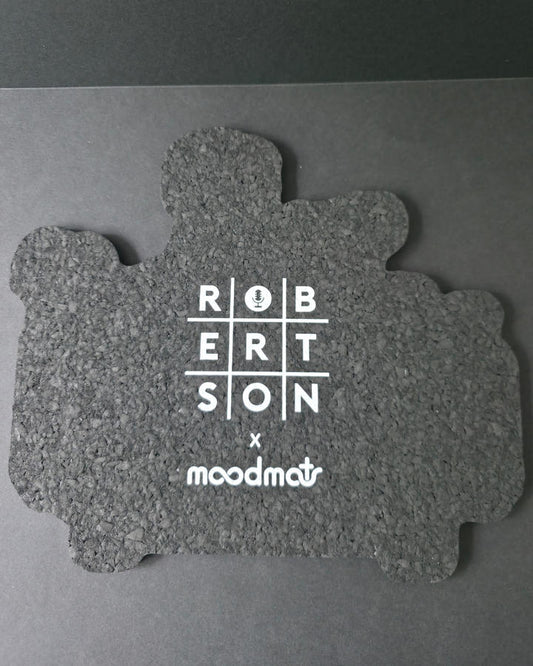 Gray puzzle piece-shaped mat with 'RobeRtson x moodmat' branding on a gray background