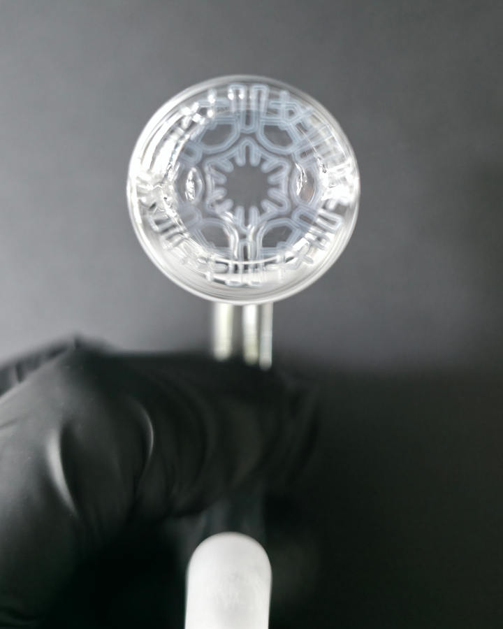 Clear Bronson glass quartz banger on a dark grey background