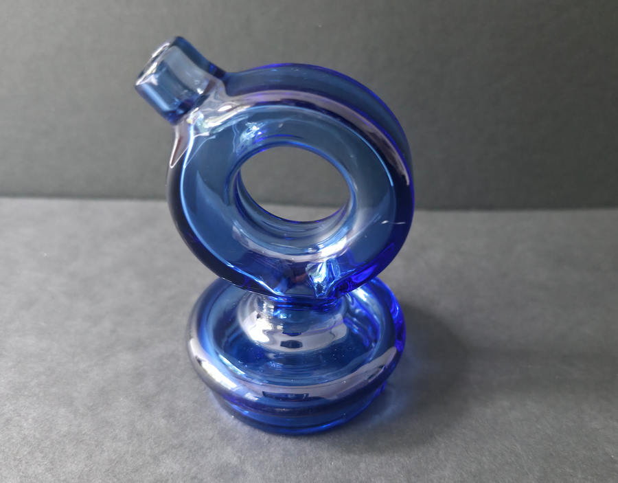 Blue glass pipe on a gray surface