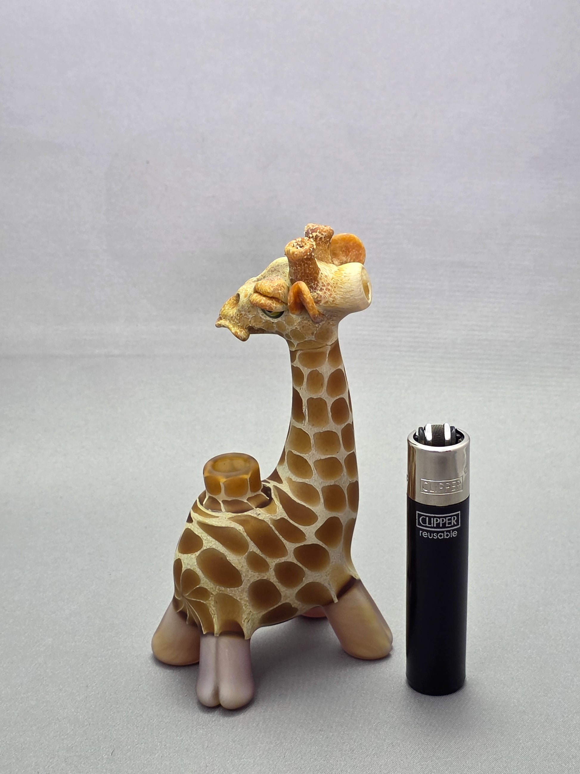 Robertson Glass Giraffe-shaped glass pipe on a light grey background