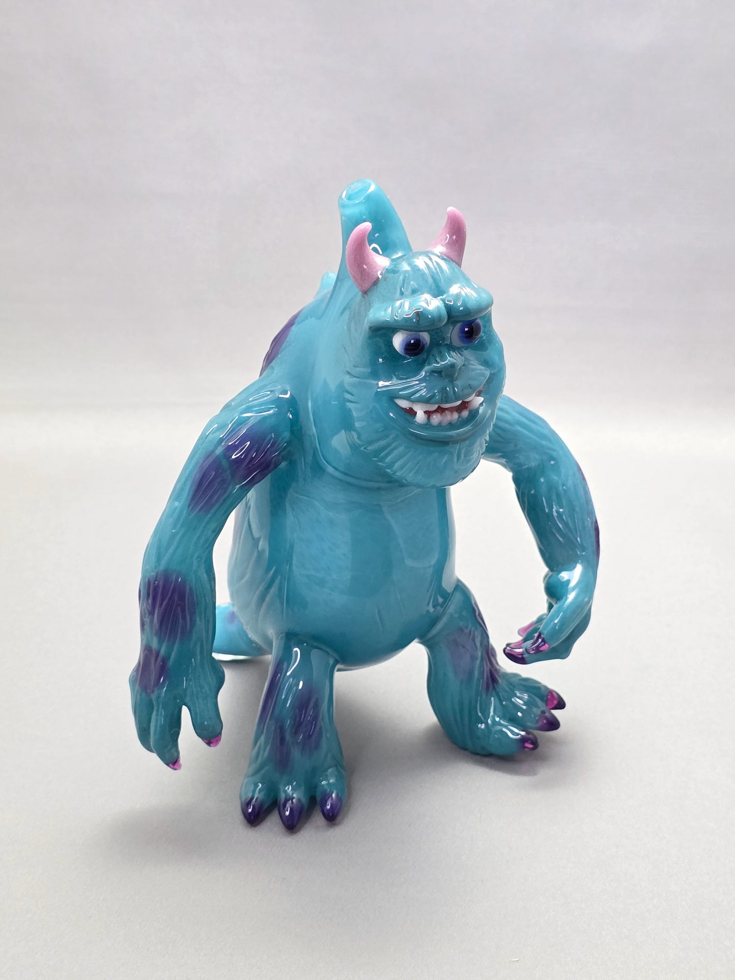 Robertson Glass Rig Blue monster figurine with purple spots on a white background