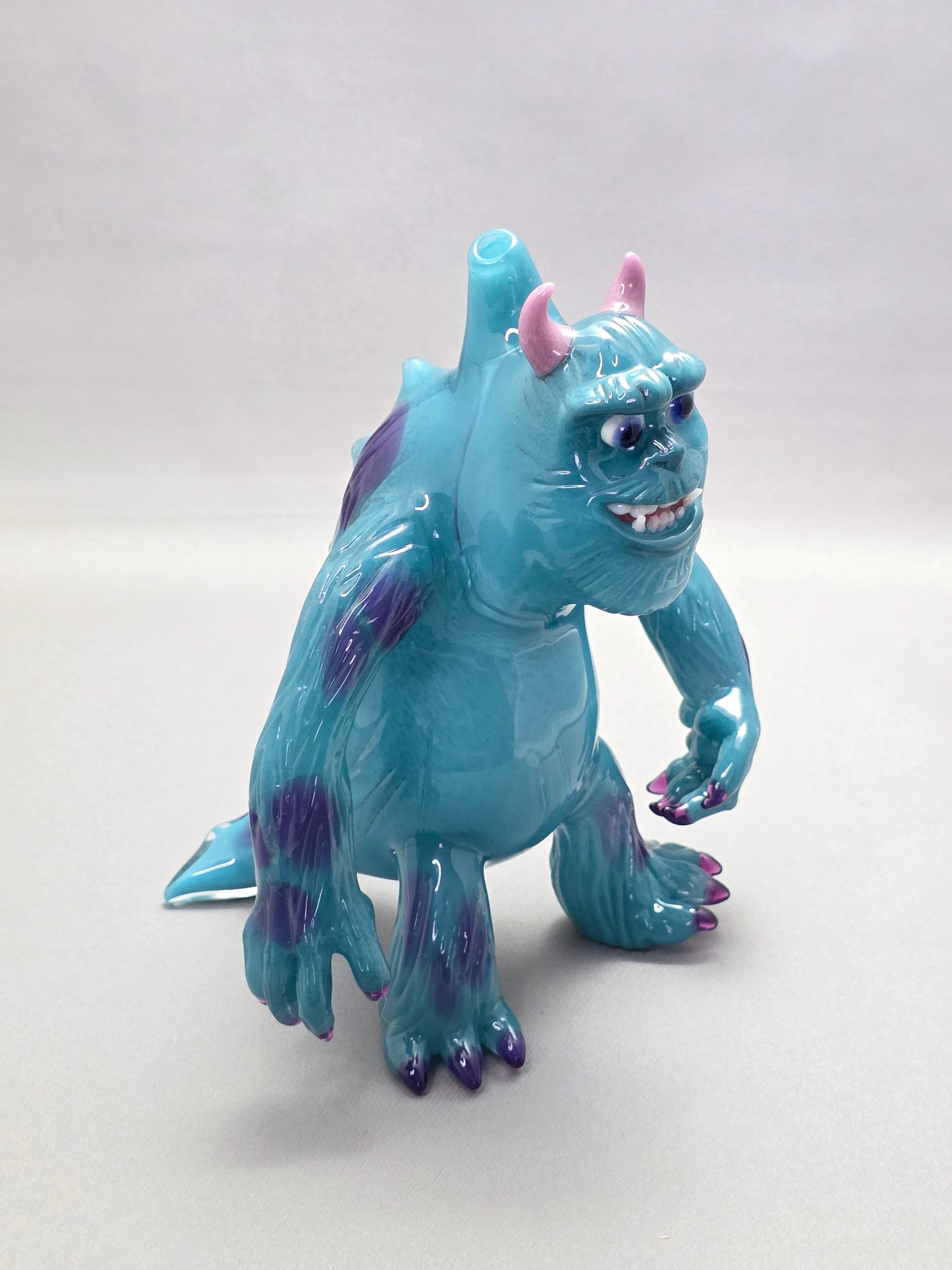 Robertson Glass Rig Blue monster figurine with purple spots on a white background