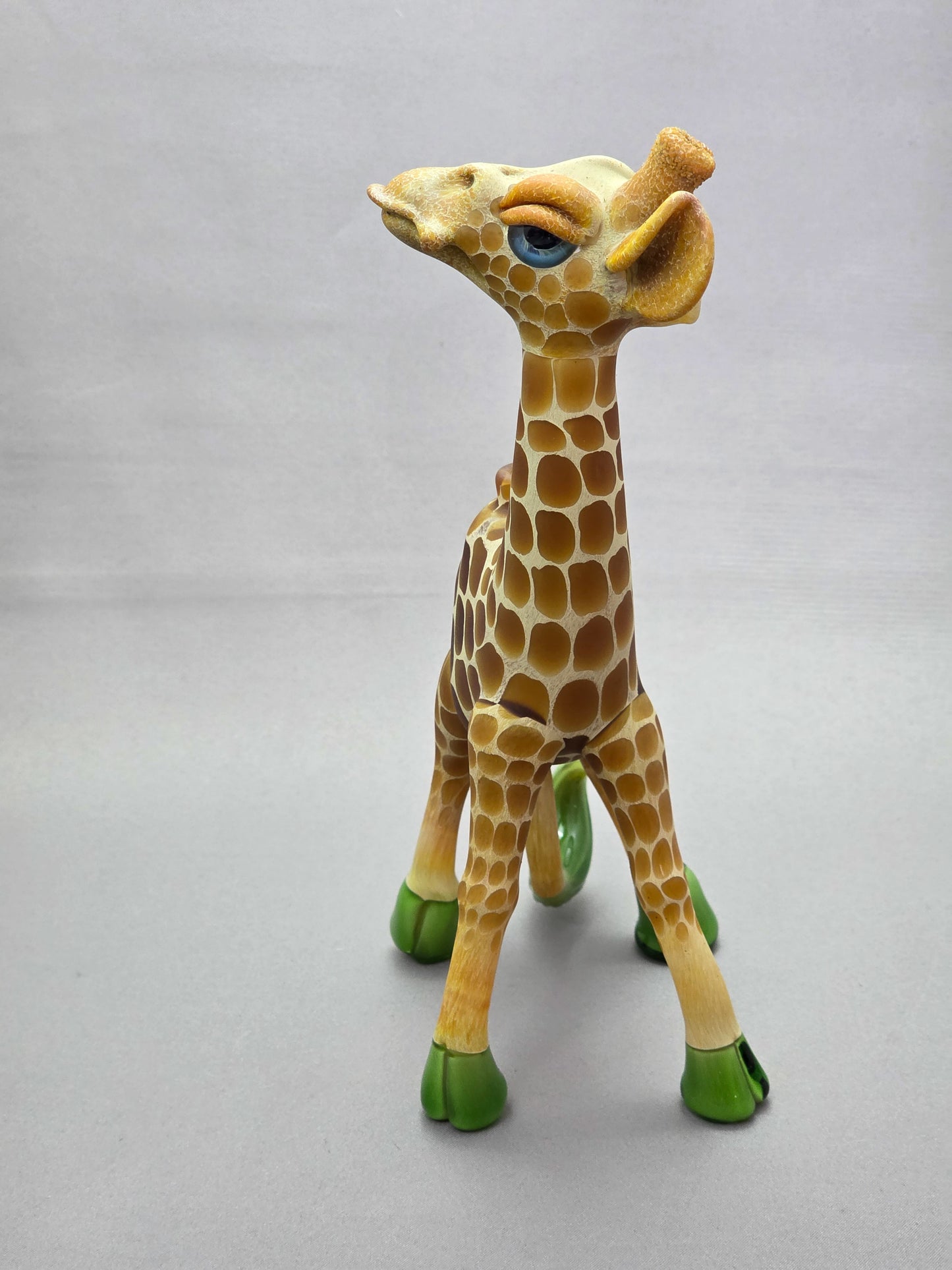 Robertson Glass Giraffe-shaped glass pipe on a light grey background