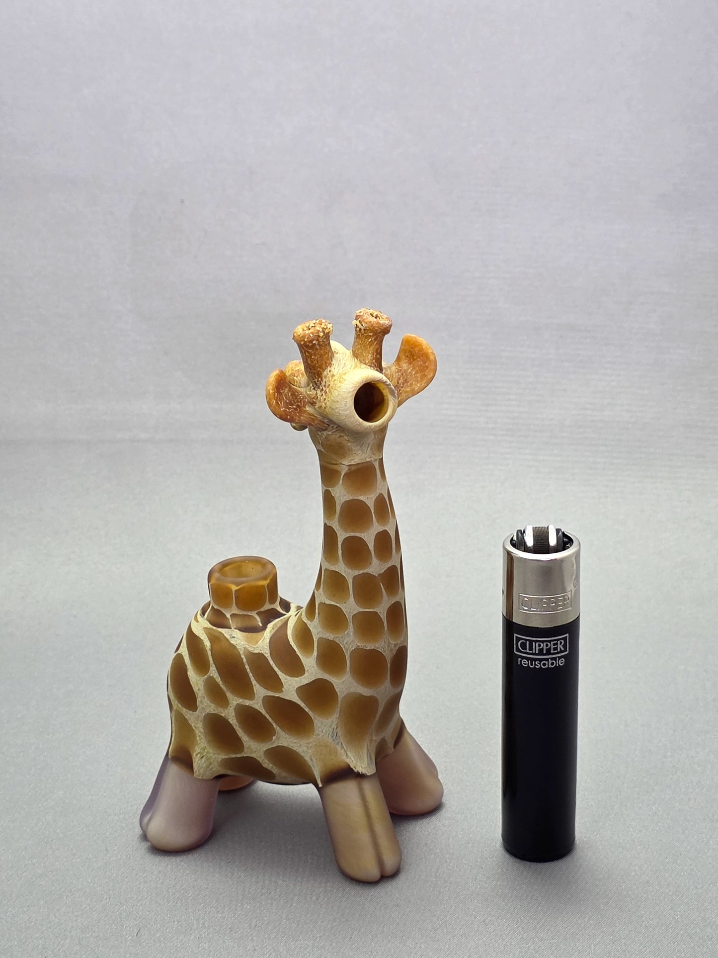 Robertson Glass Giraffe-shaped glass pipe on a light grey background