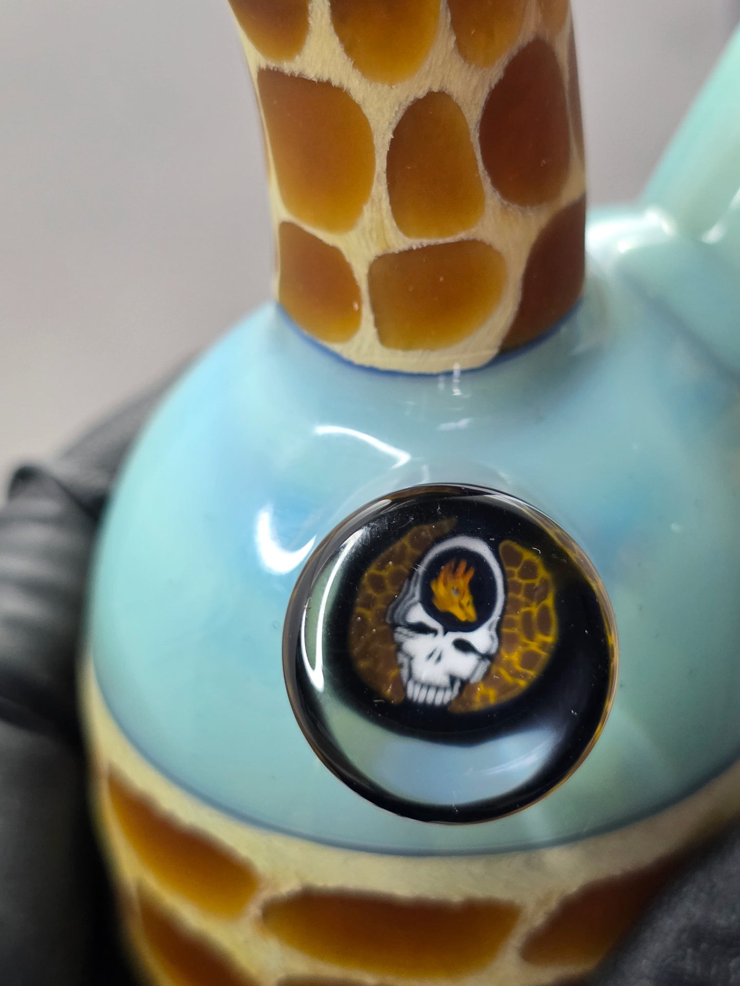 Robertson Glass blue giraffe pattern glass rig on a light grey background
