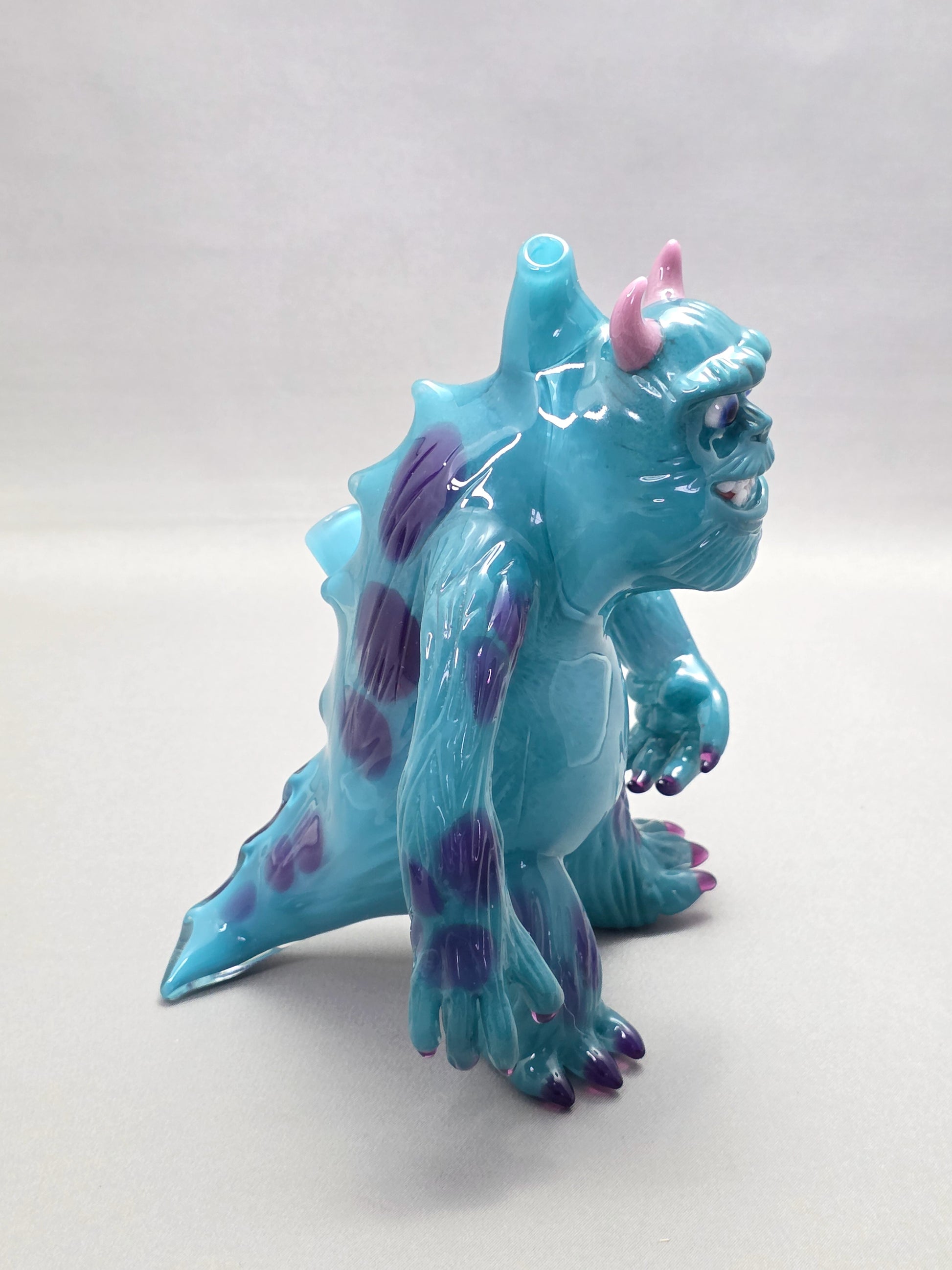 Robertson Glass Rig Blue monster figurine with purple spots on a white background