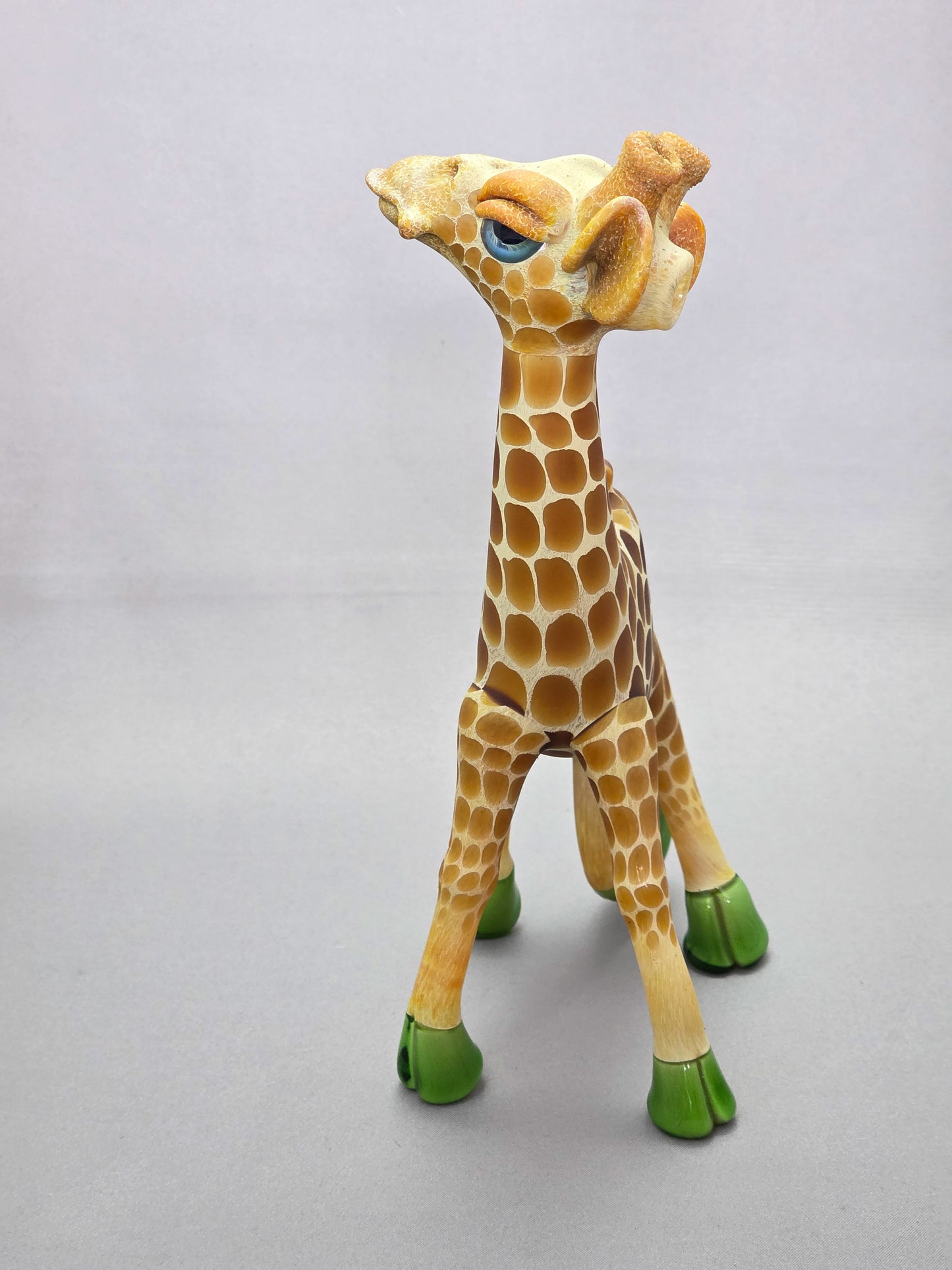 Robertson Glass Giraffe-shaped glass pipe on a light grey background