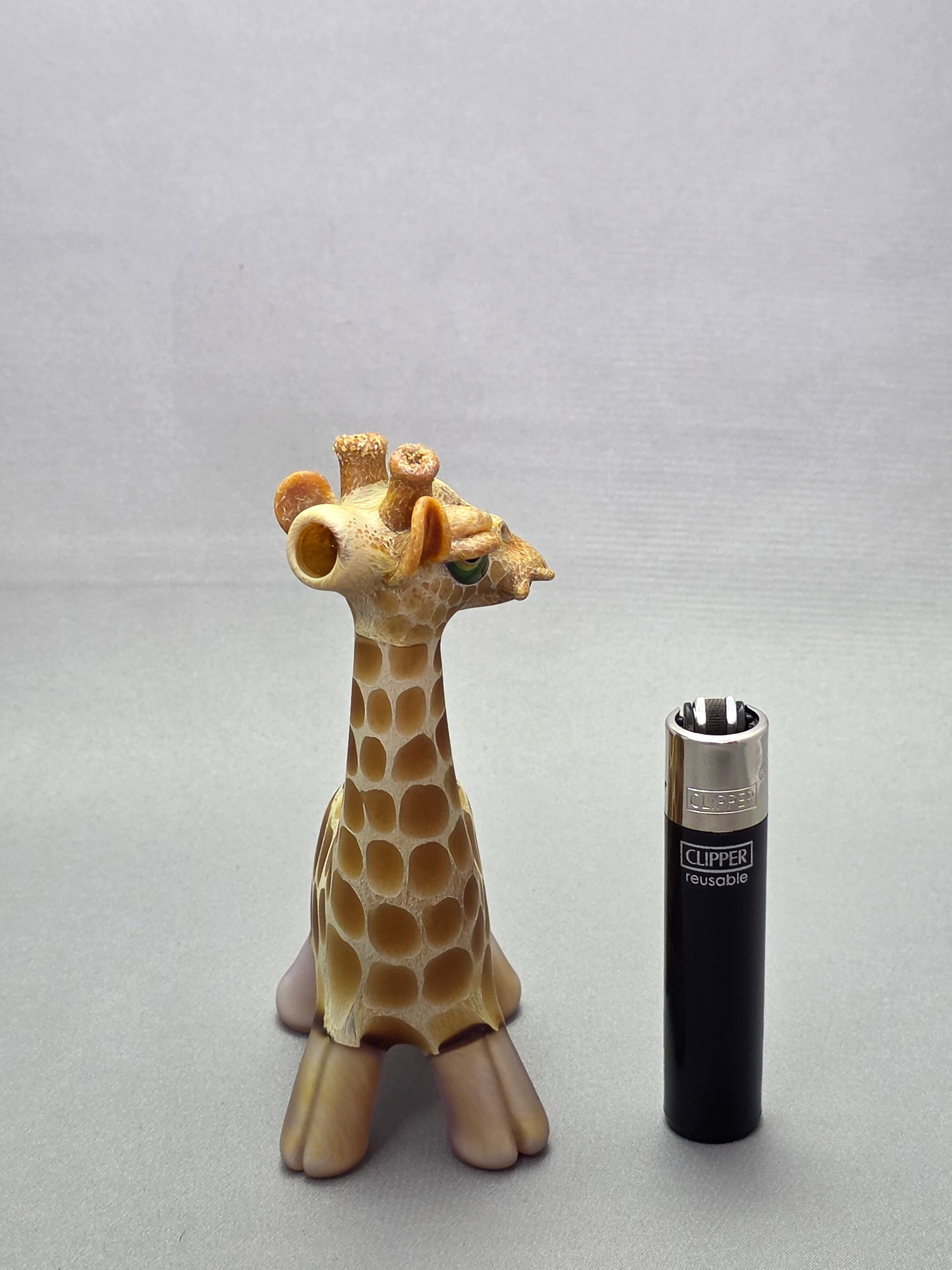 Robertson Glass Giraffe-shaped glass pipe on a light grey background