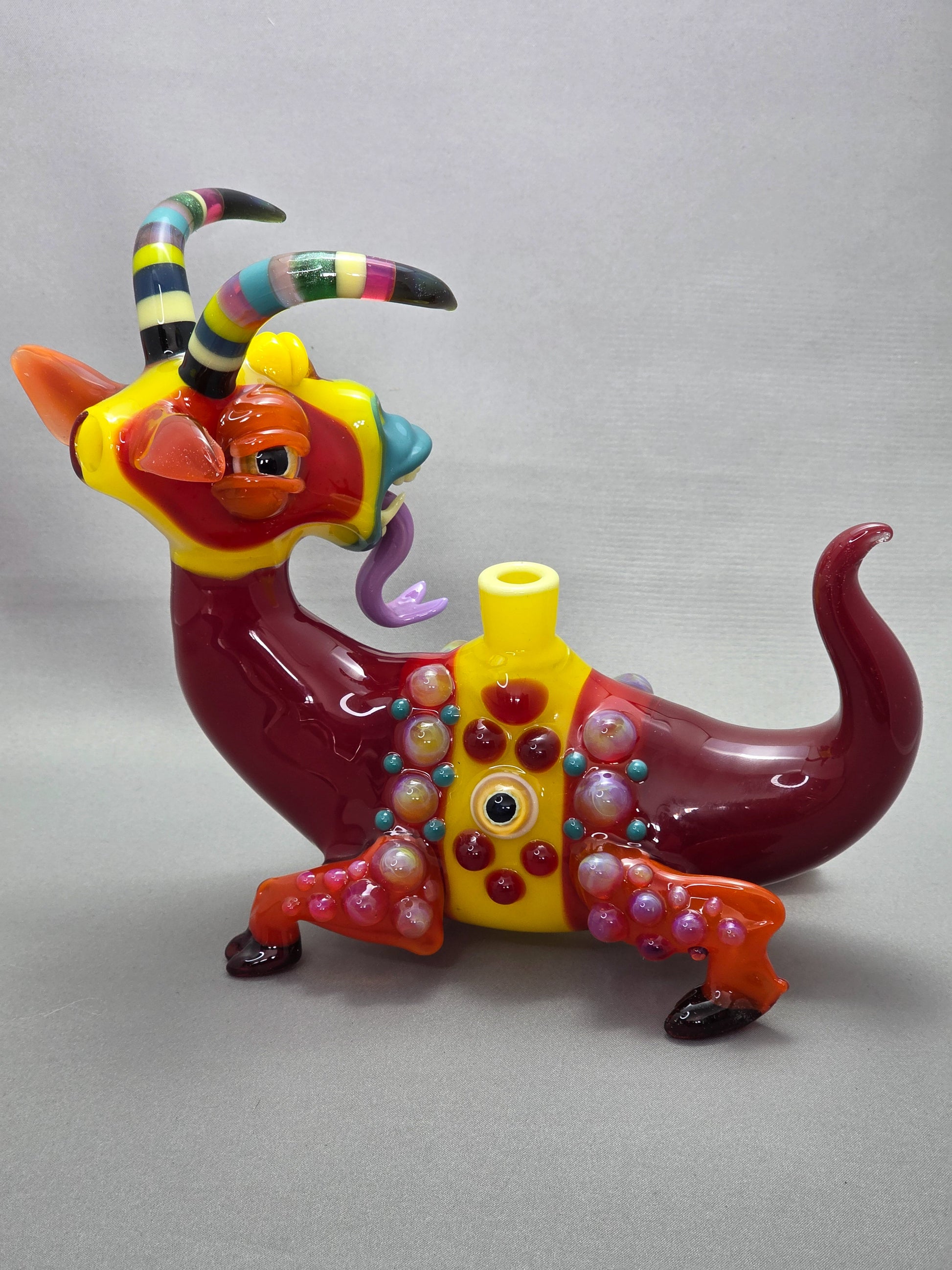 Robertson Glass Colourful glass Goat sculpture on a grey background