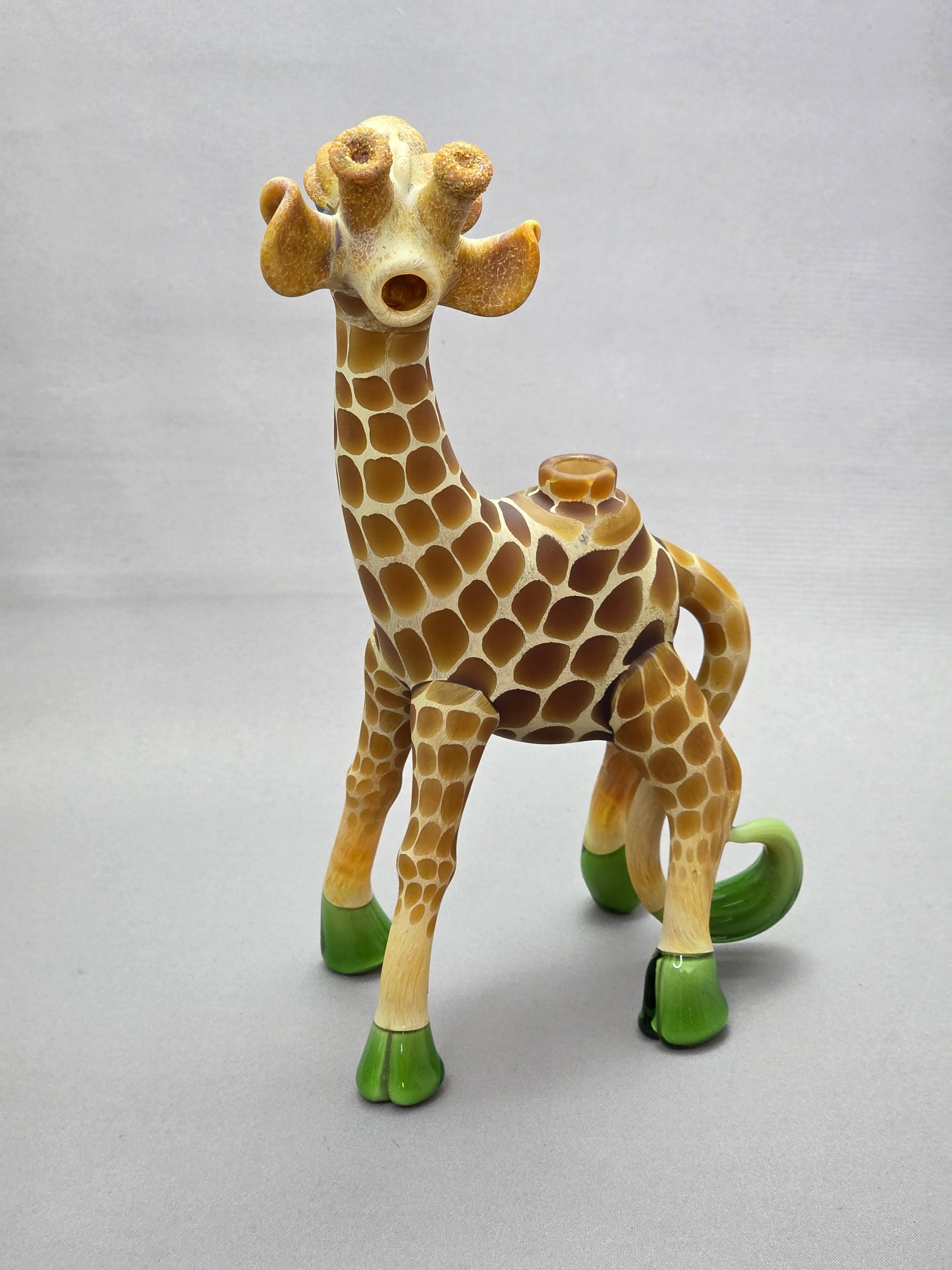 Robertson Glass Giraffe-shaped glass pipe on a light grey background