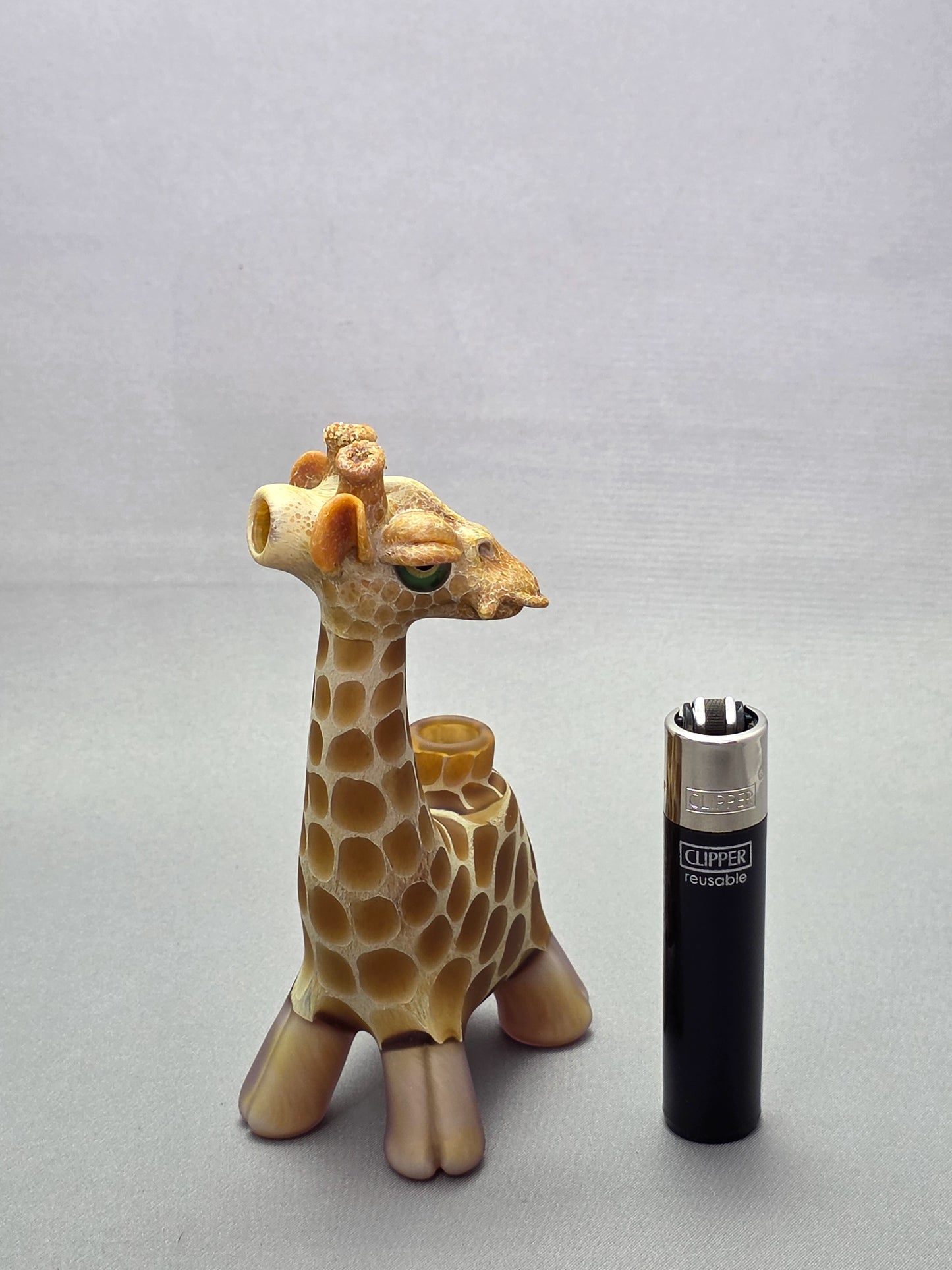 Robertson Glass Giraffe-shaped glass pipe on a light grey background