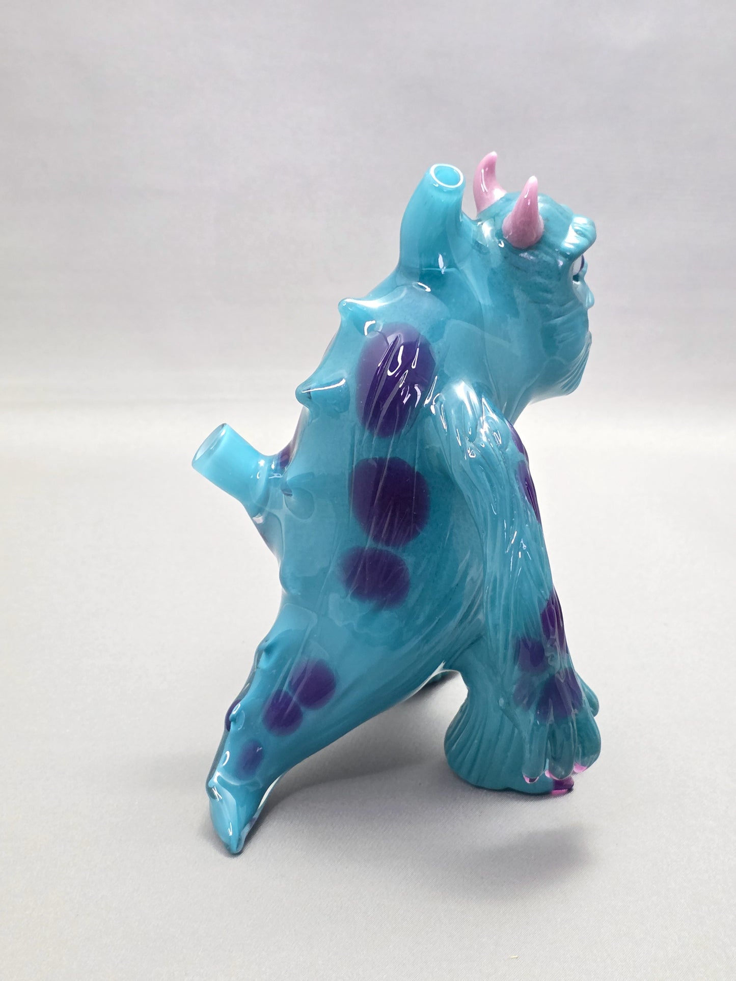 Robertson Glass Rig Blue monster figurine with purple spots on a white background