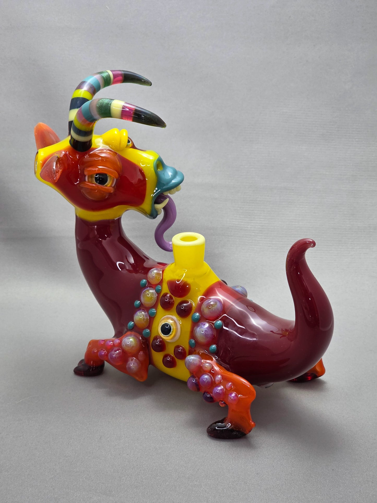 Robertson Glass Colourful glass Goat sculpture on a grey background