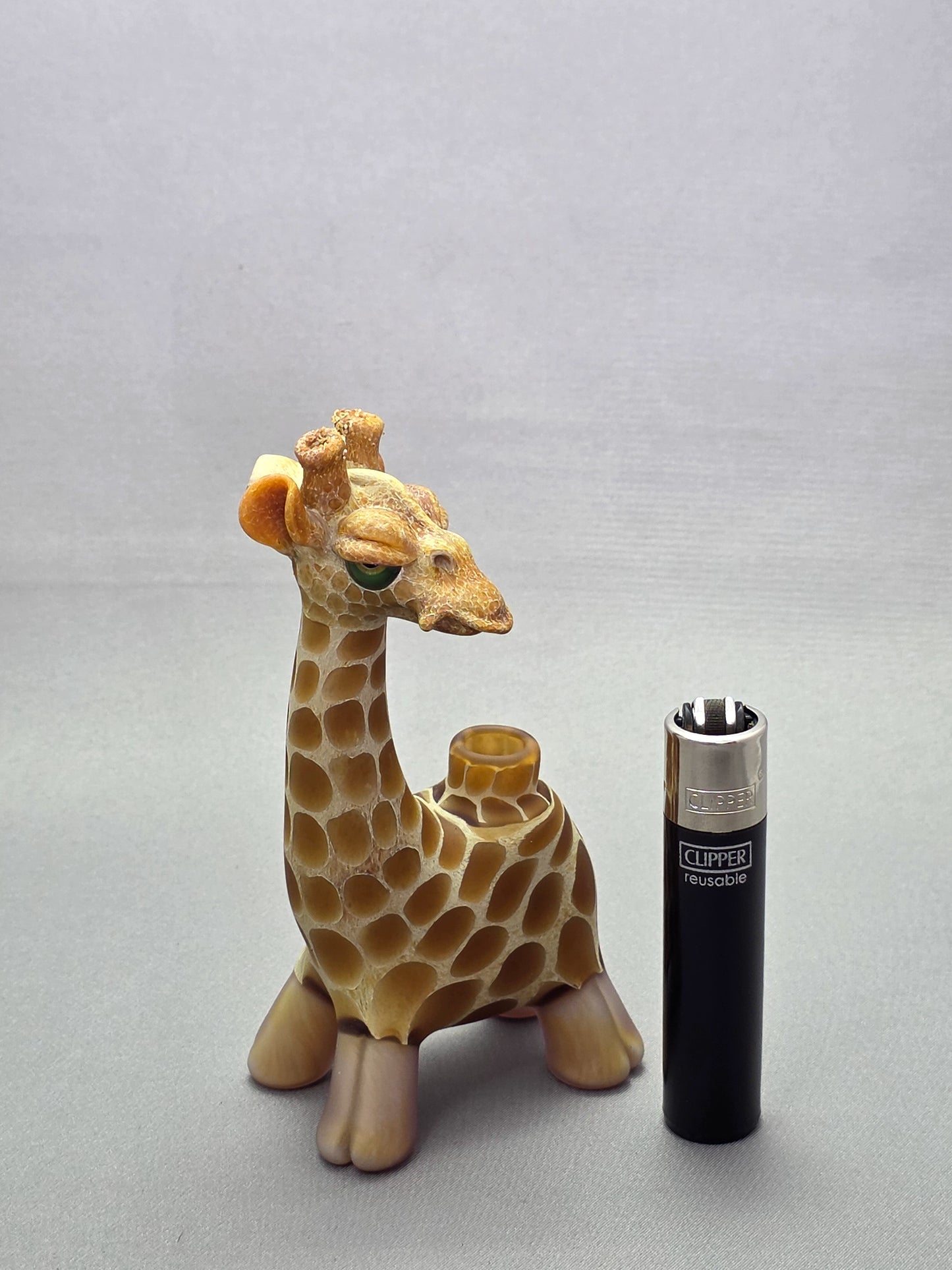 Robertson Glass Giraffe-shaped glass pipe on a light grey background