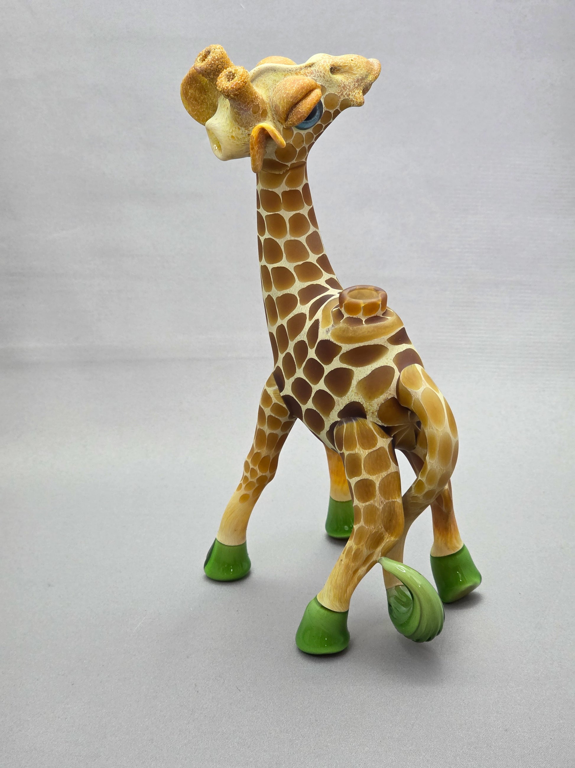 Robertson Glass Giraffe-shaped glass pipe on a light grey background