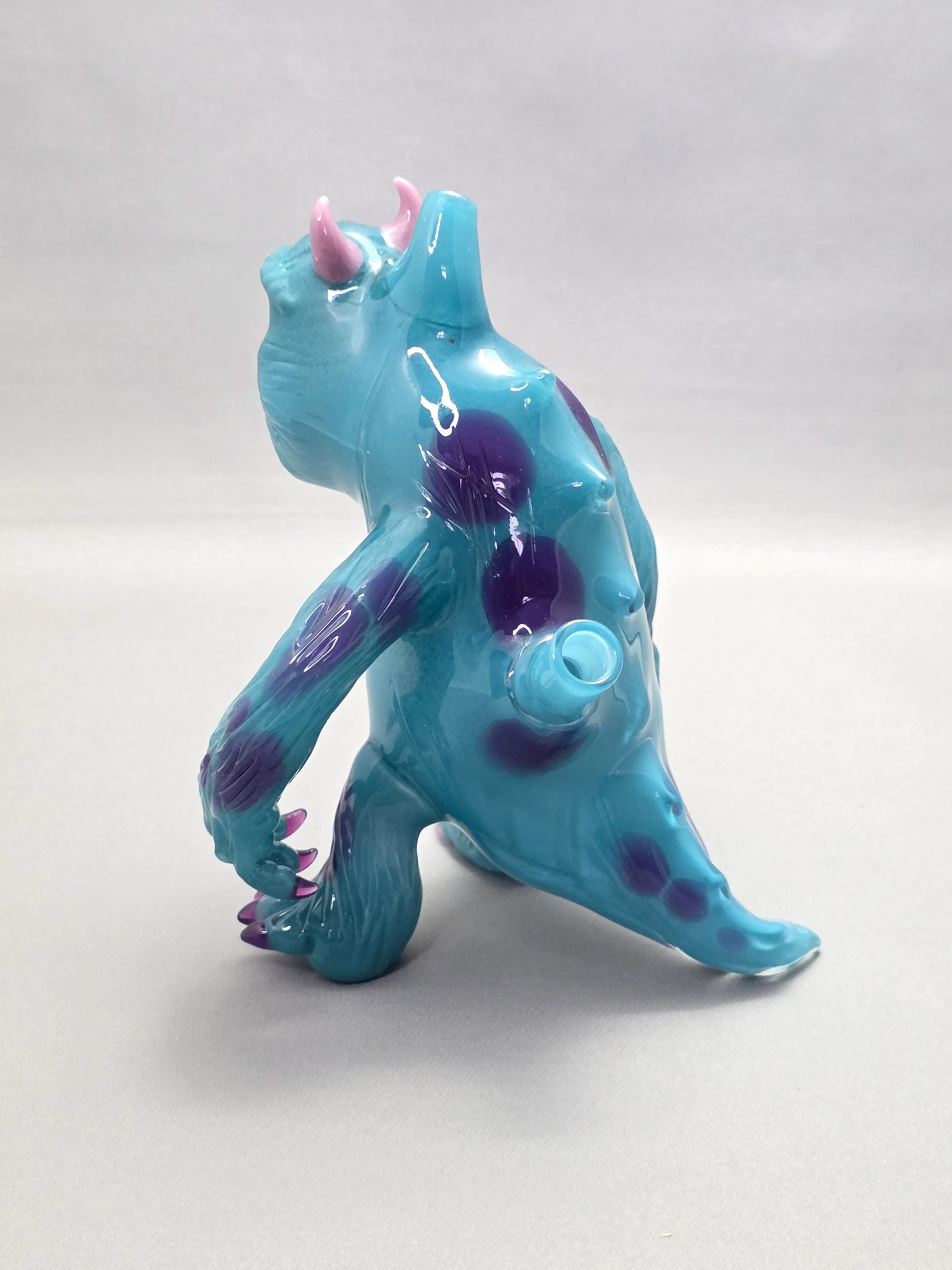 Robertson Glass Rig Blue monster figurine with purple spots on a white background